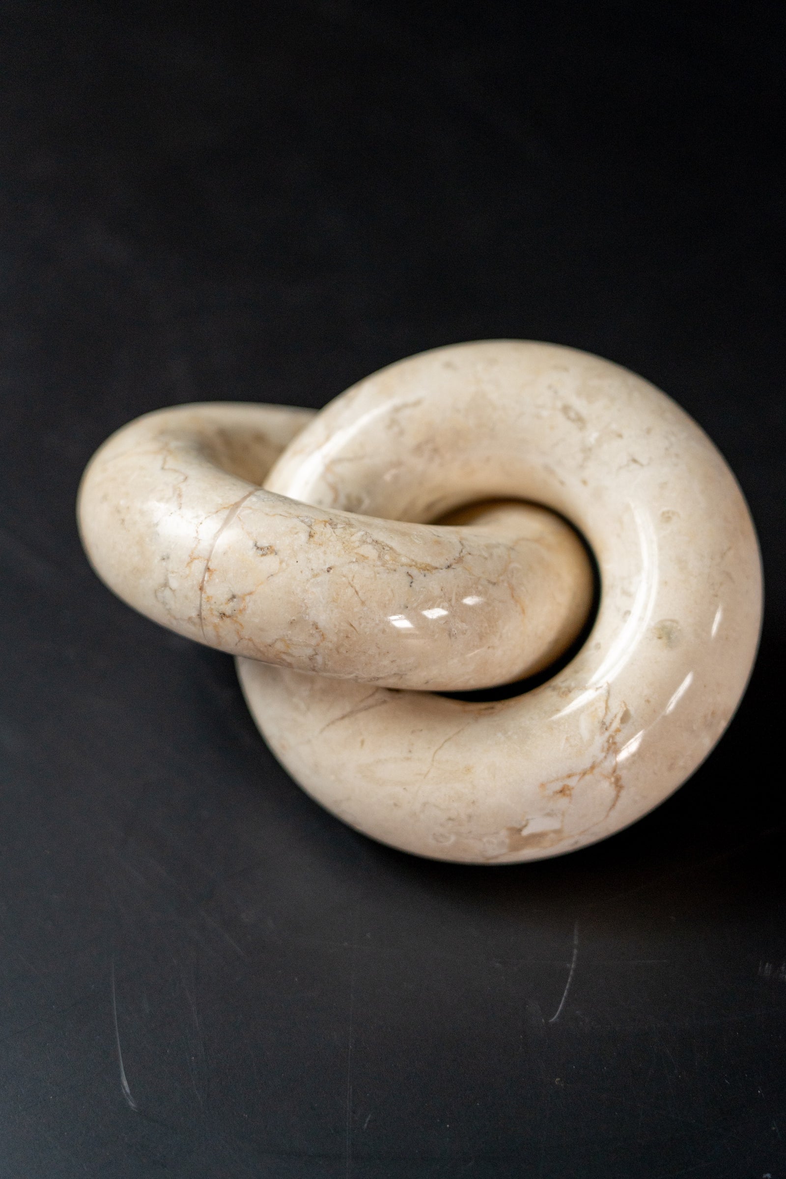 Solid marble decorative chain-link ornament with natural veining