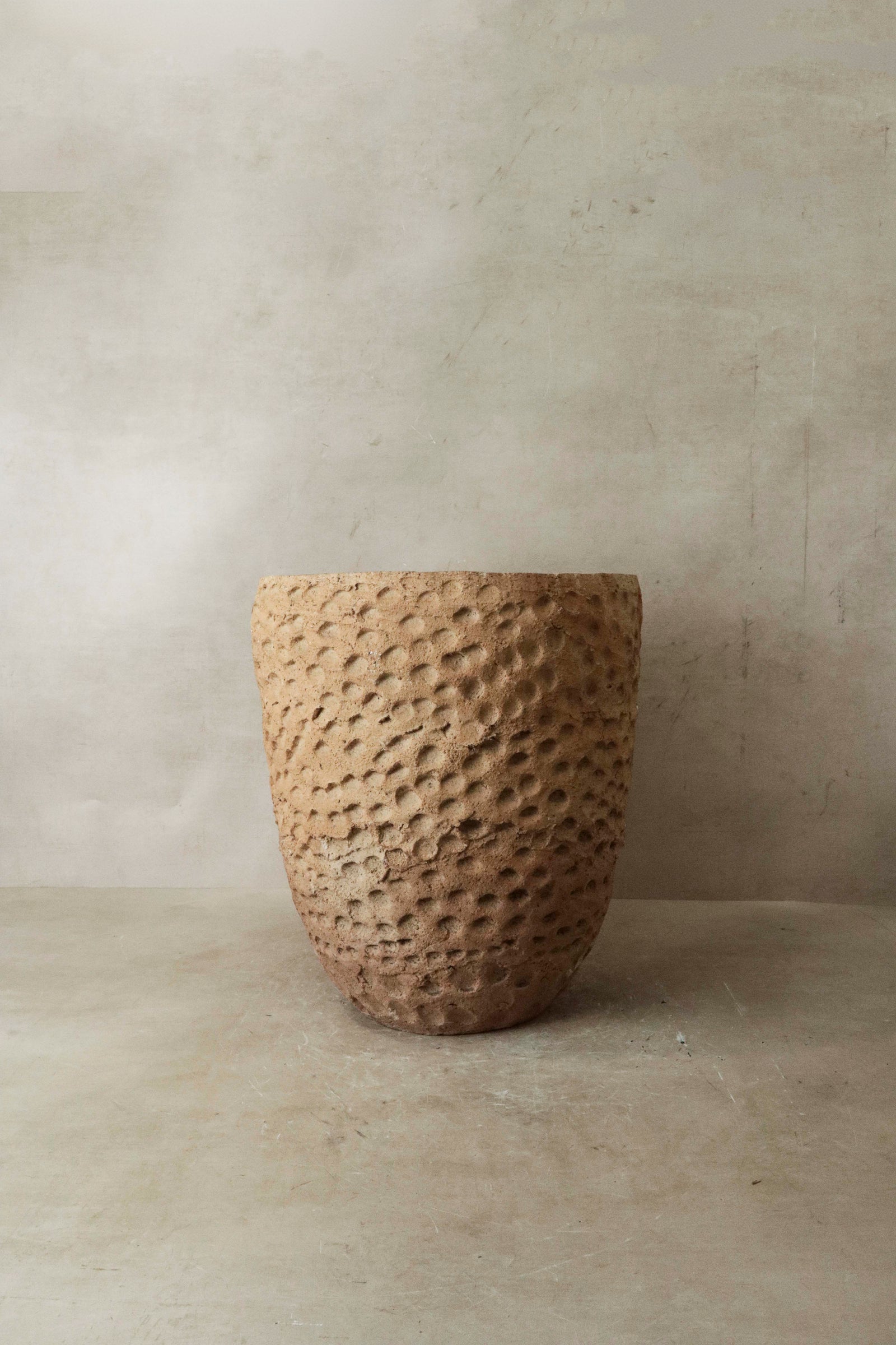 Textured hand-thrown Gwayi clay pot from Zimbabwe in earthy tones
