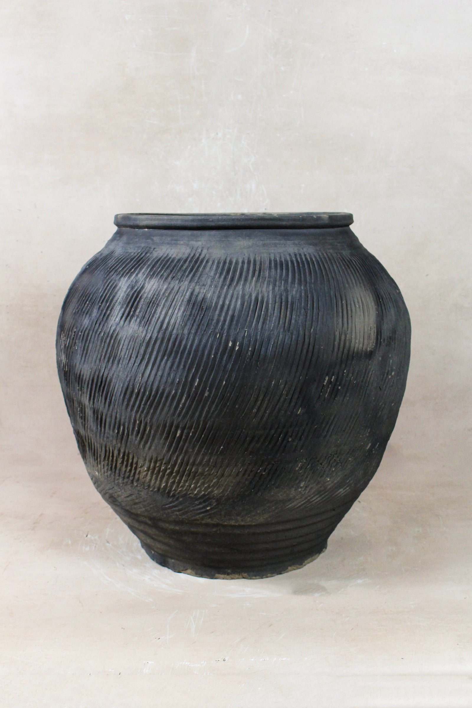 Vintage grey clay pot — detail of the textured firing marks