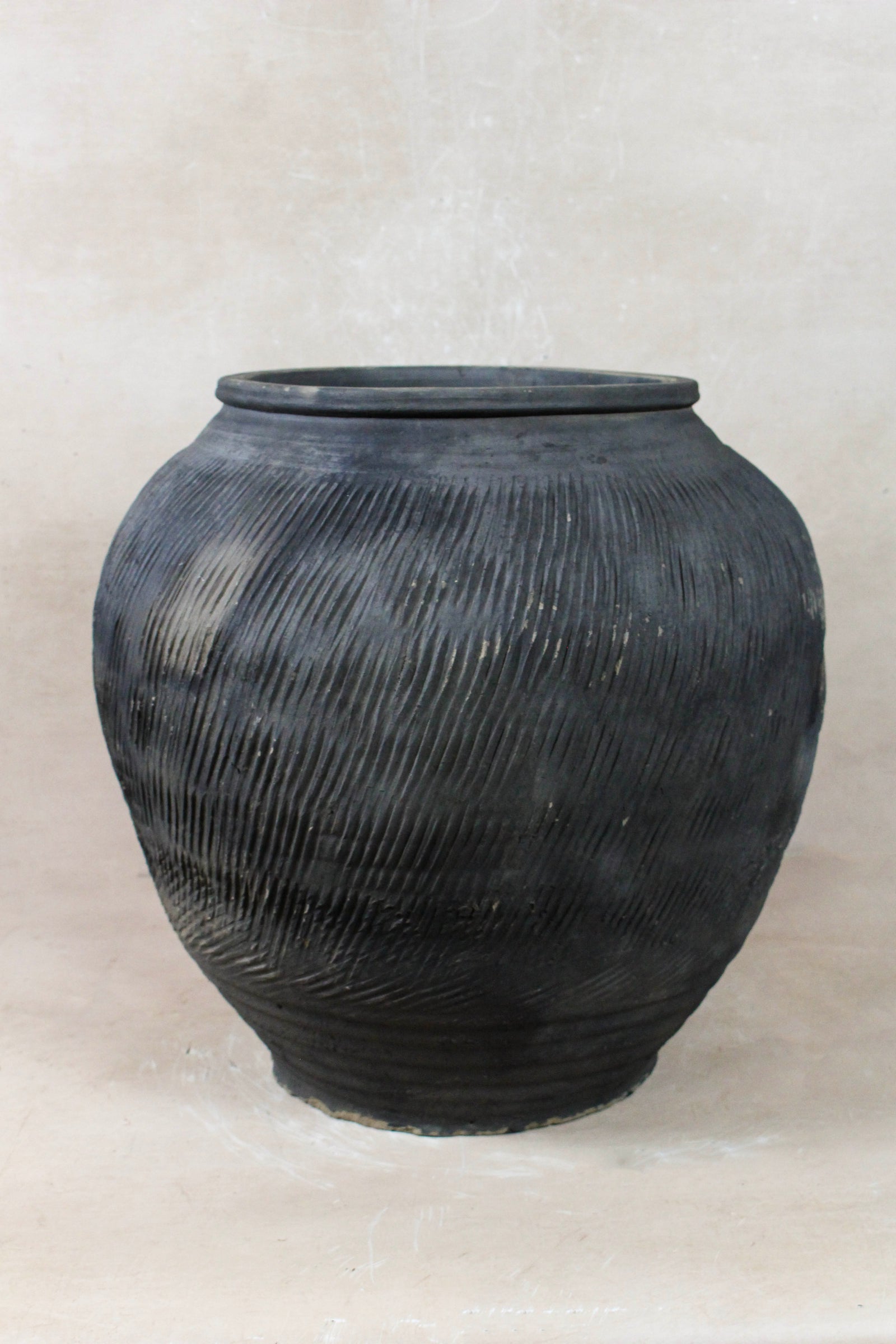 Vintage grey clay pot — side view showing the aged patina