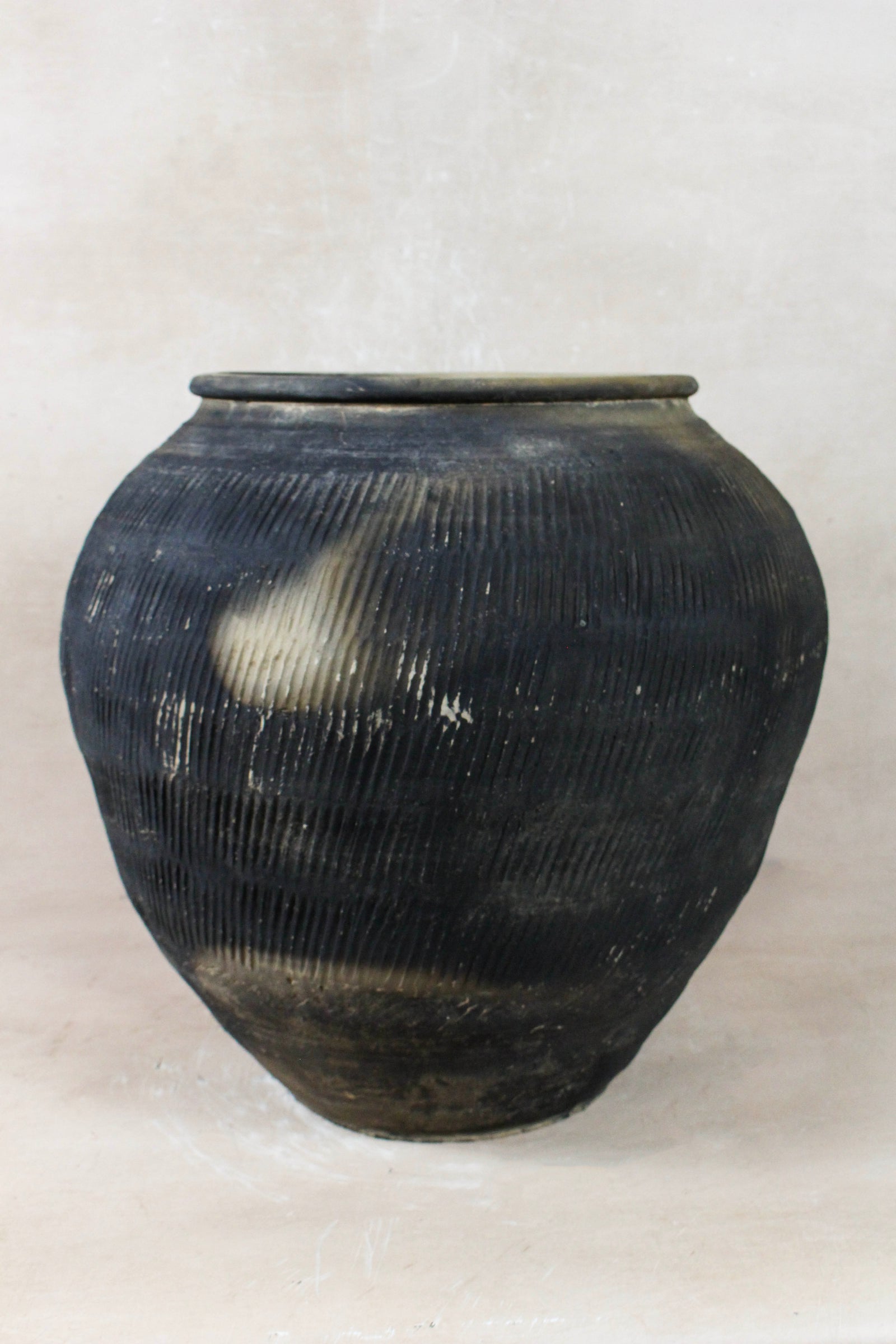 Vintage grey clay pot — detail of the textured firing marks