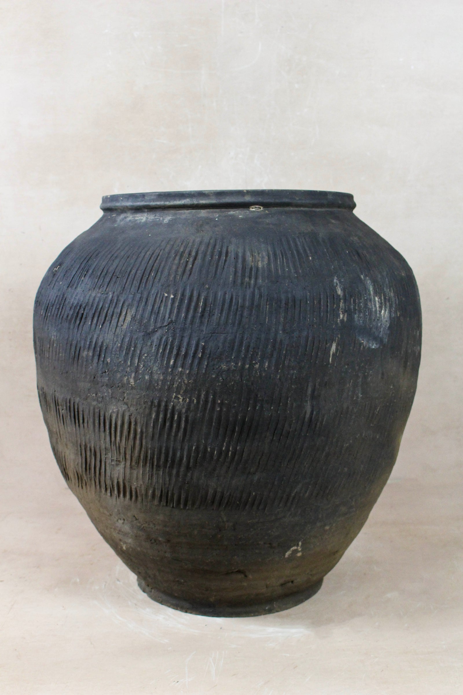 Vintage grey clay pot — side view showing the aged patina