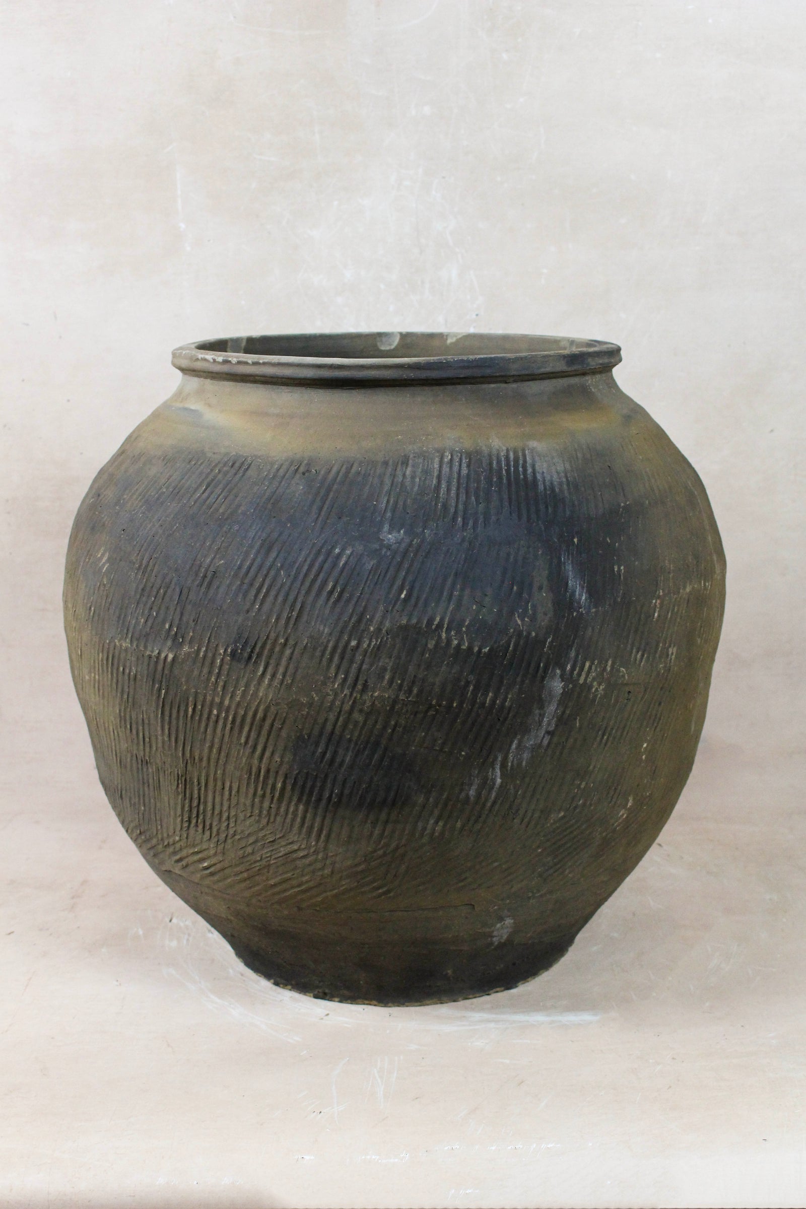 Vintage grey clay pot — detail of the textured firing marks