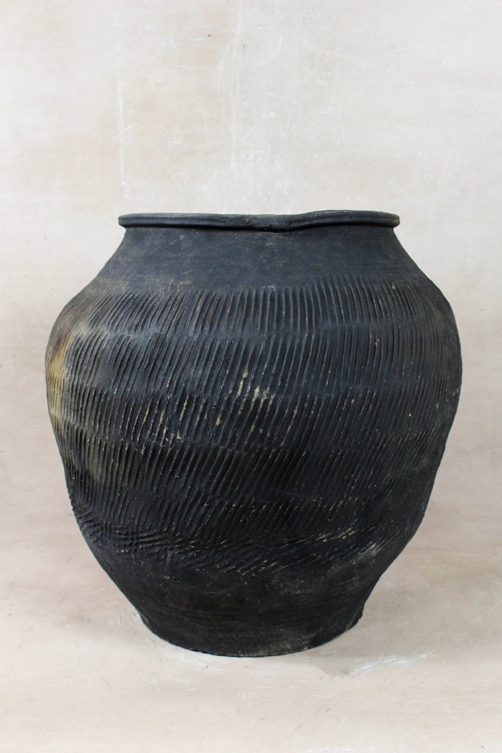 Vintage grey clay pot — detail of the textured firing marks