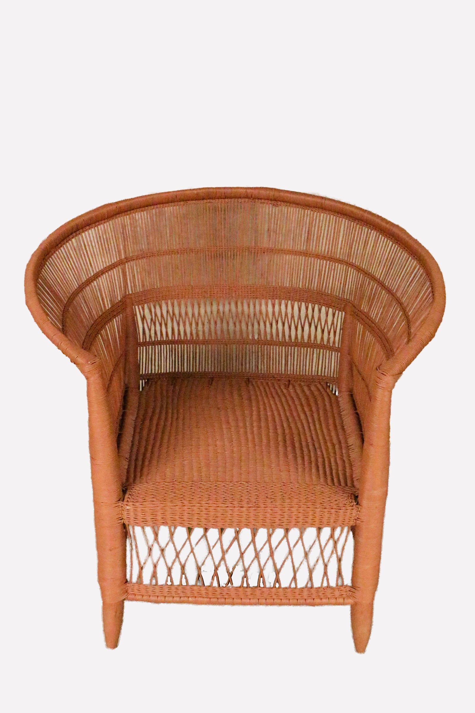 Handwoven burnt orange rattan Malawi chair with curved barrel back