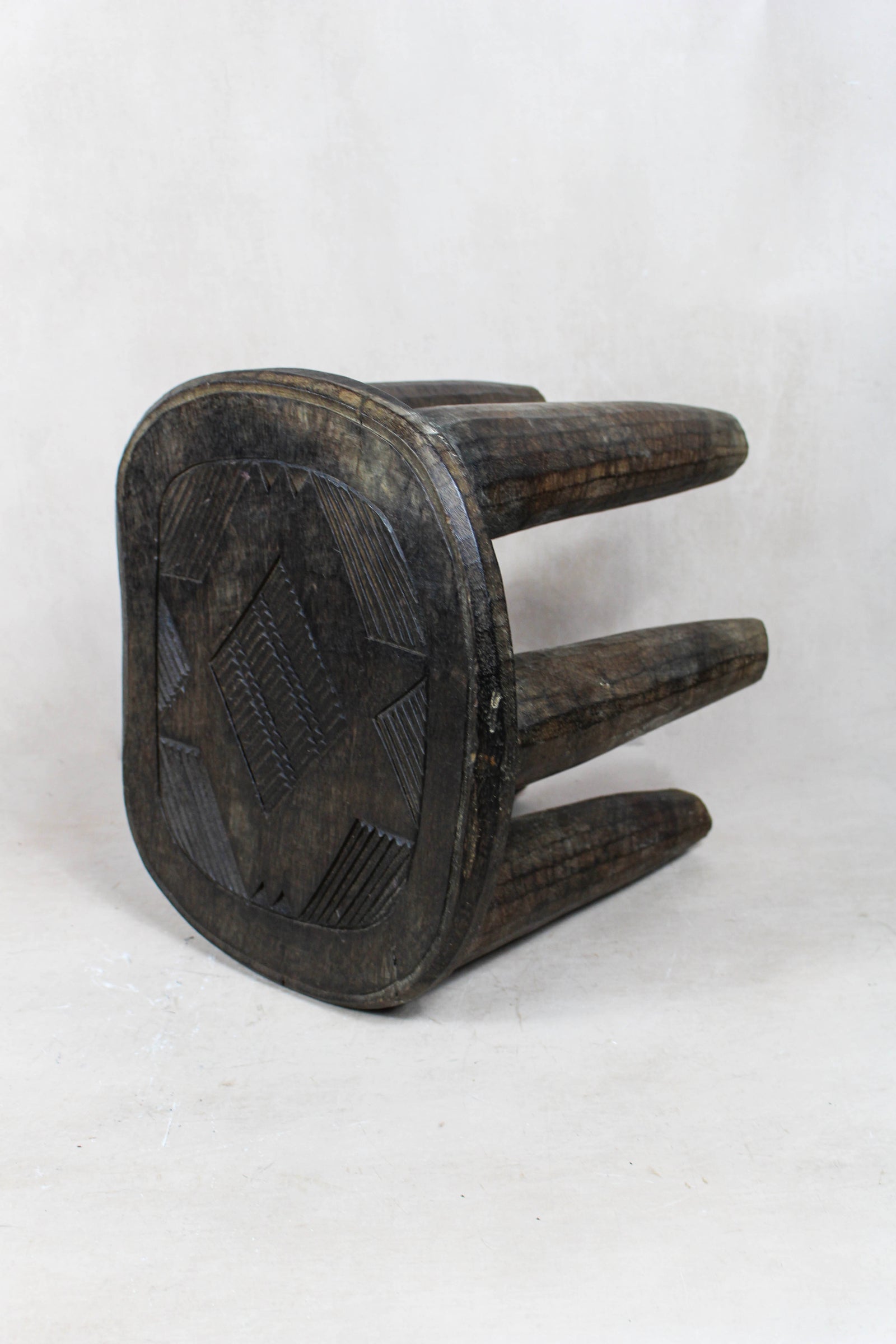 Nupe carved wood stool — detail of the carved pattern