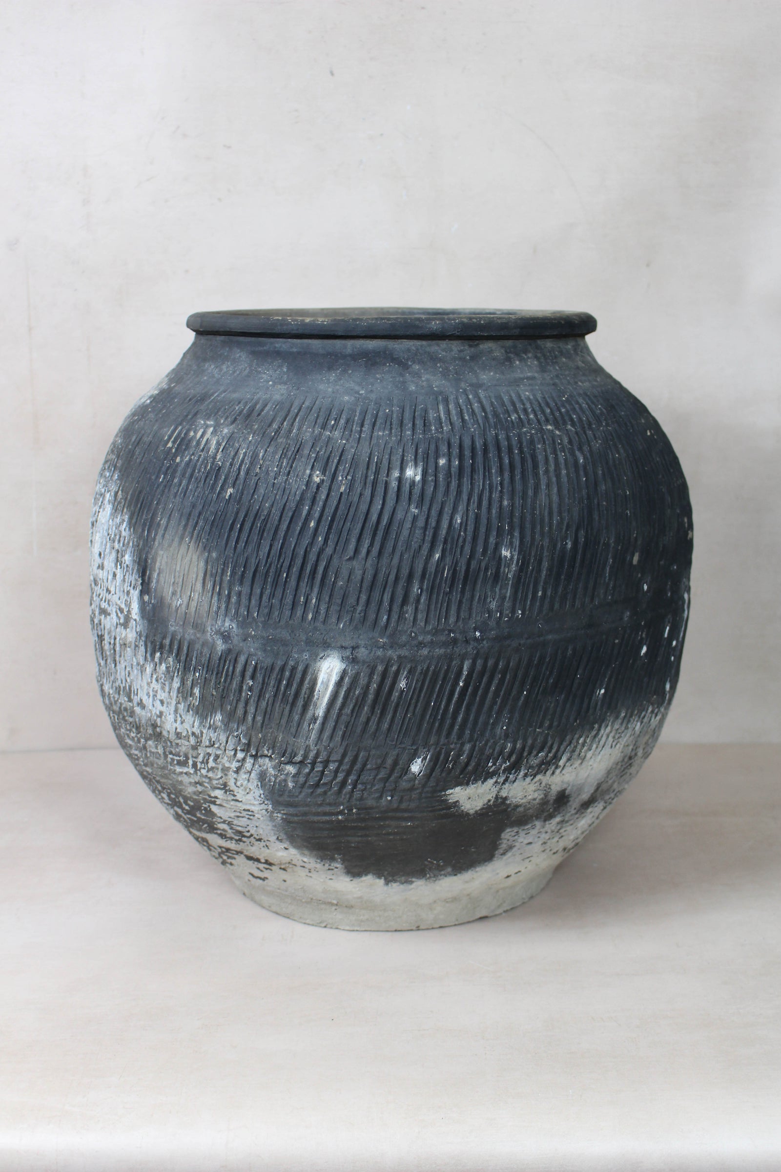 Vintage grey clay pot — detail of the textured firing marks