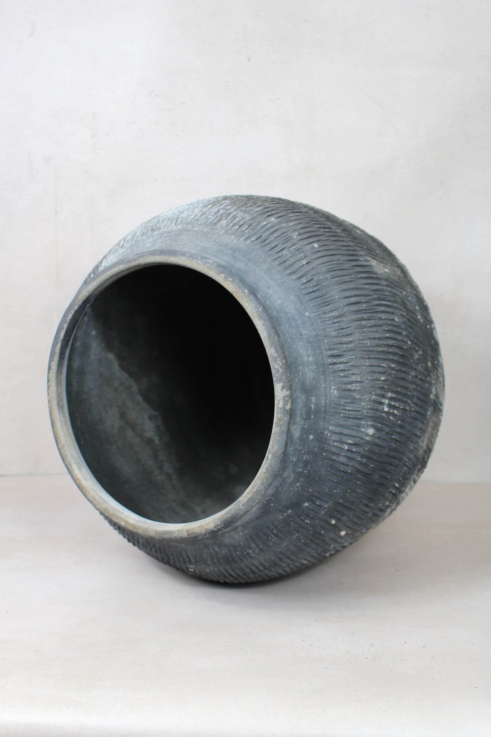 Vintage grey clay pot — side view showing the aged patina