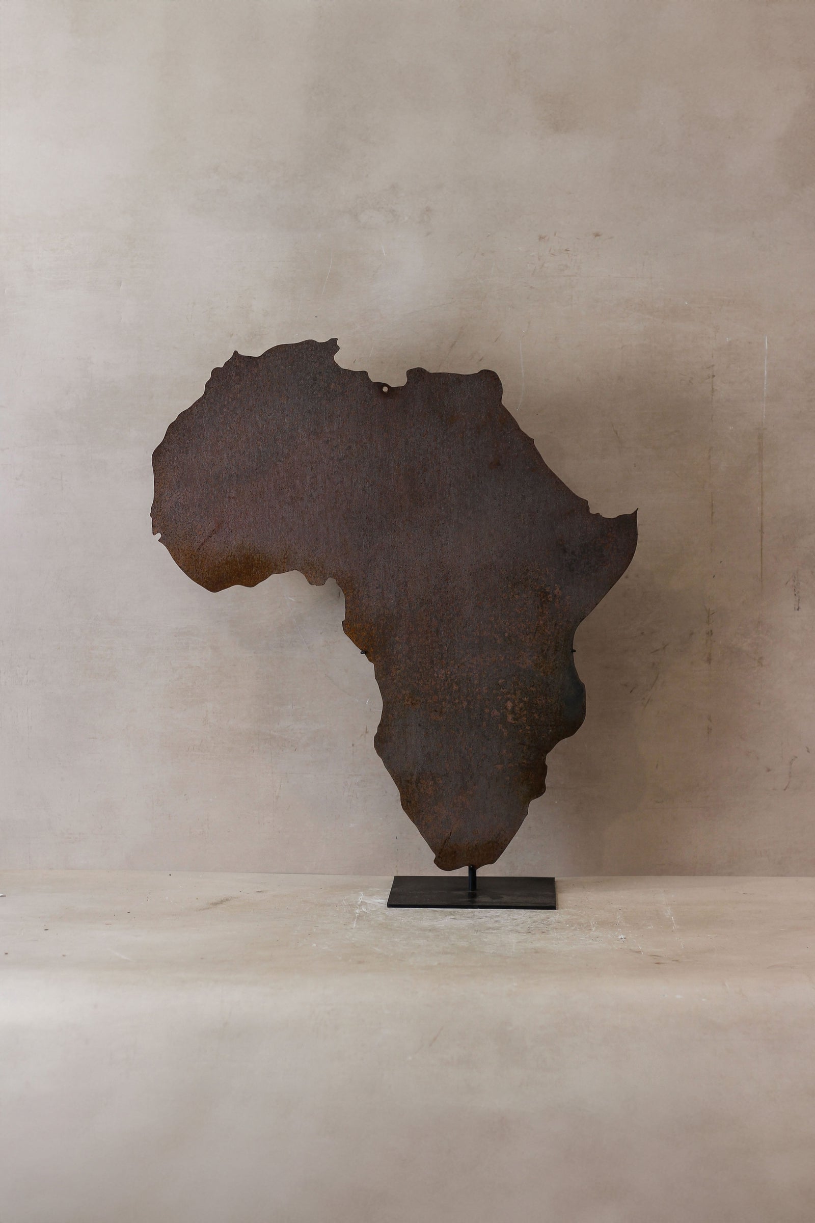 Map of Africa laser-cut from rusted Corten steel on a stand