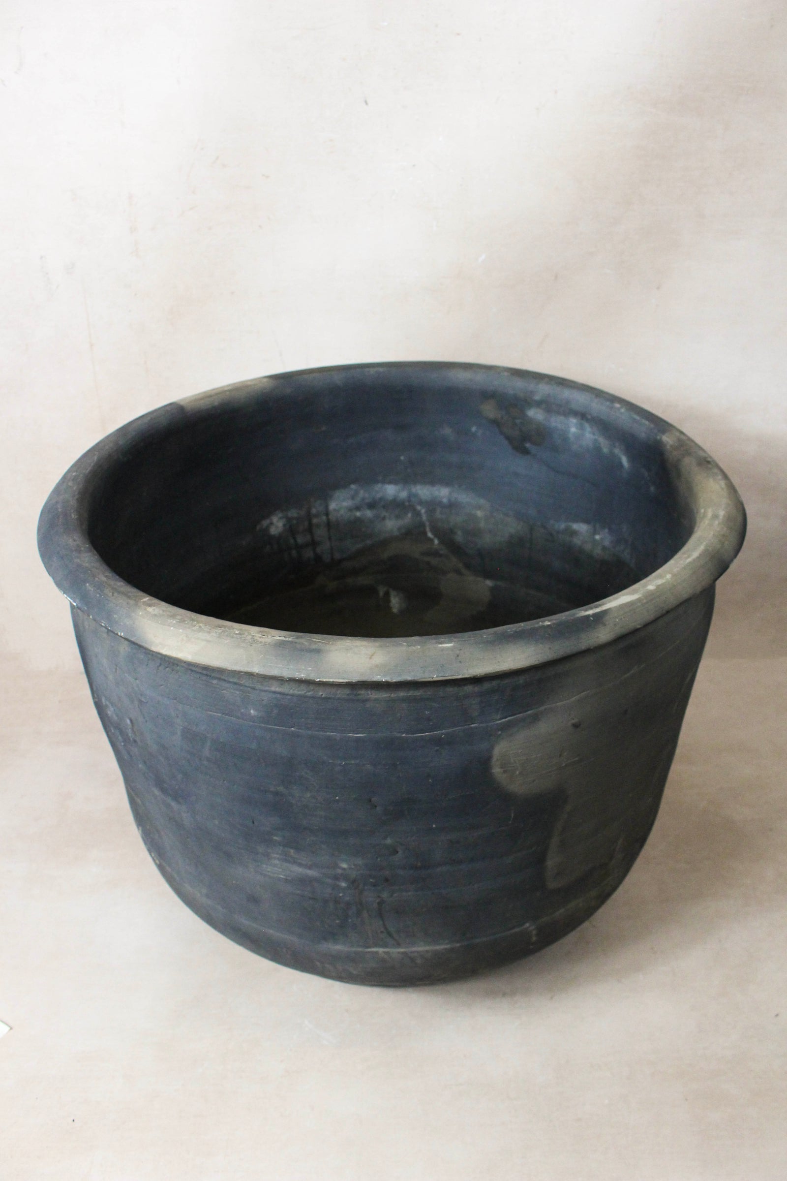 Large vintage dark clay pot — opening from above