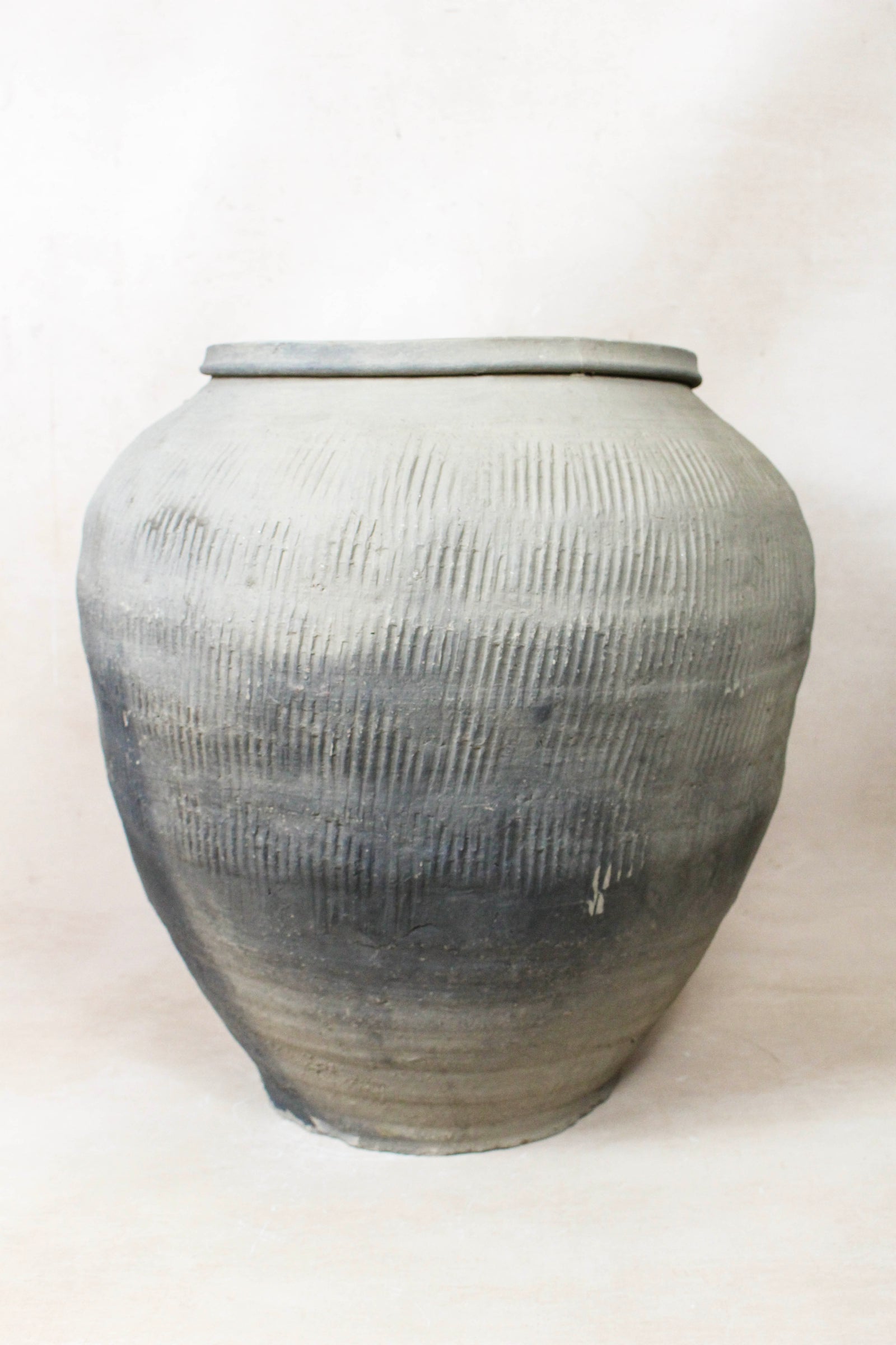 Vintage grey clay pot — detail of the textured firing marks