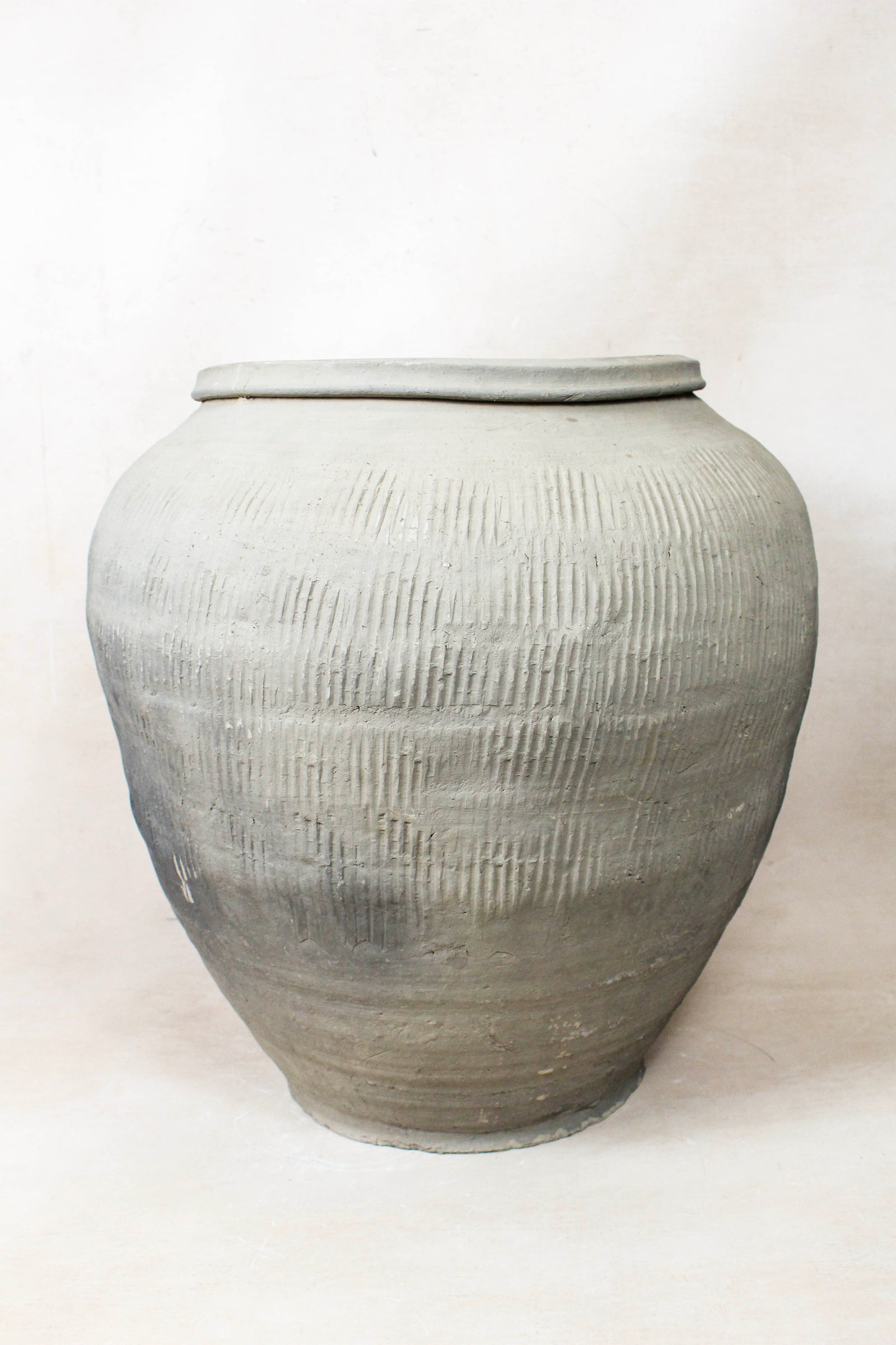 Vintage grey clay pot — side view showing the aged patina