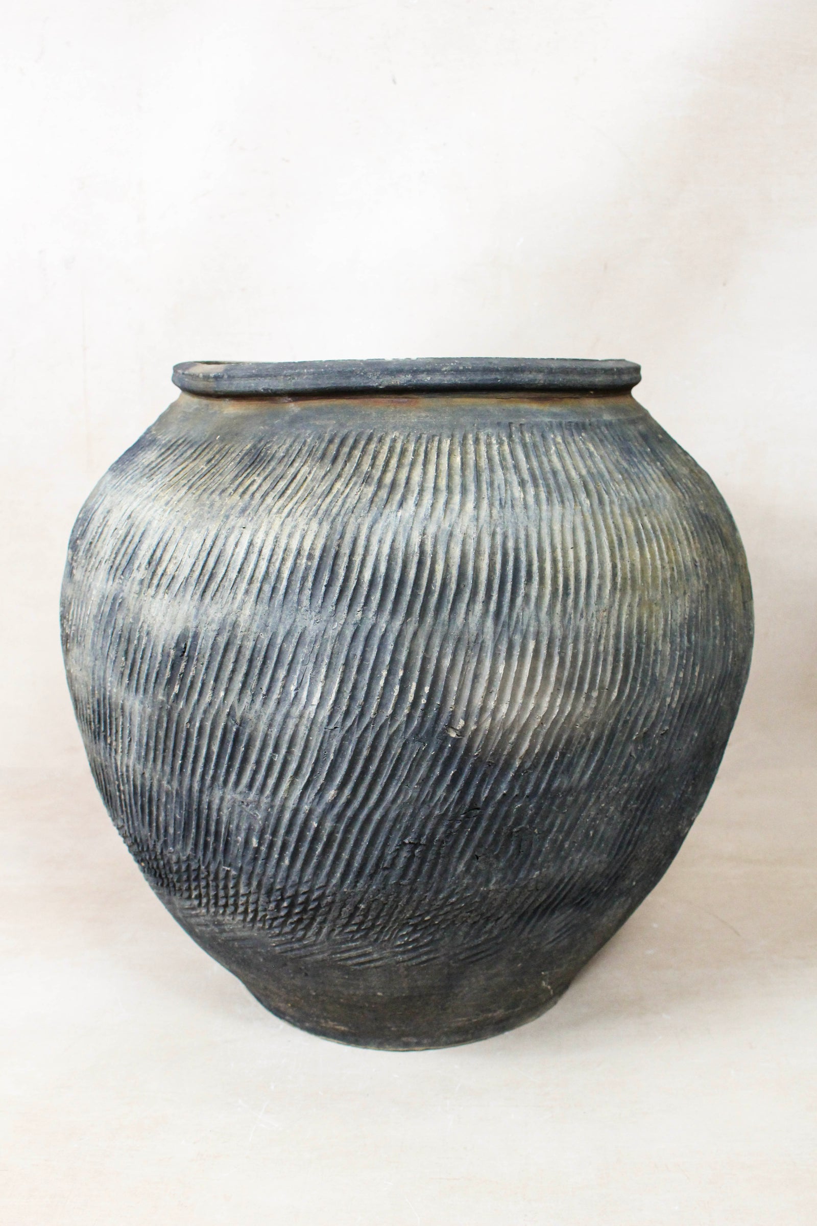 Vintage grey clay pot — detail of the textured firing marks