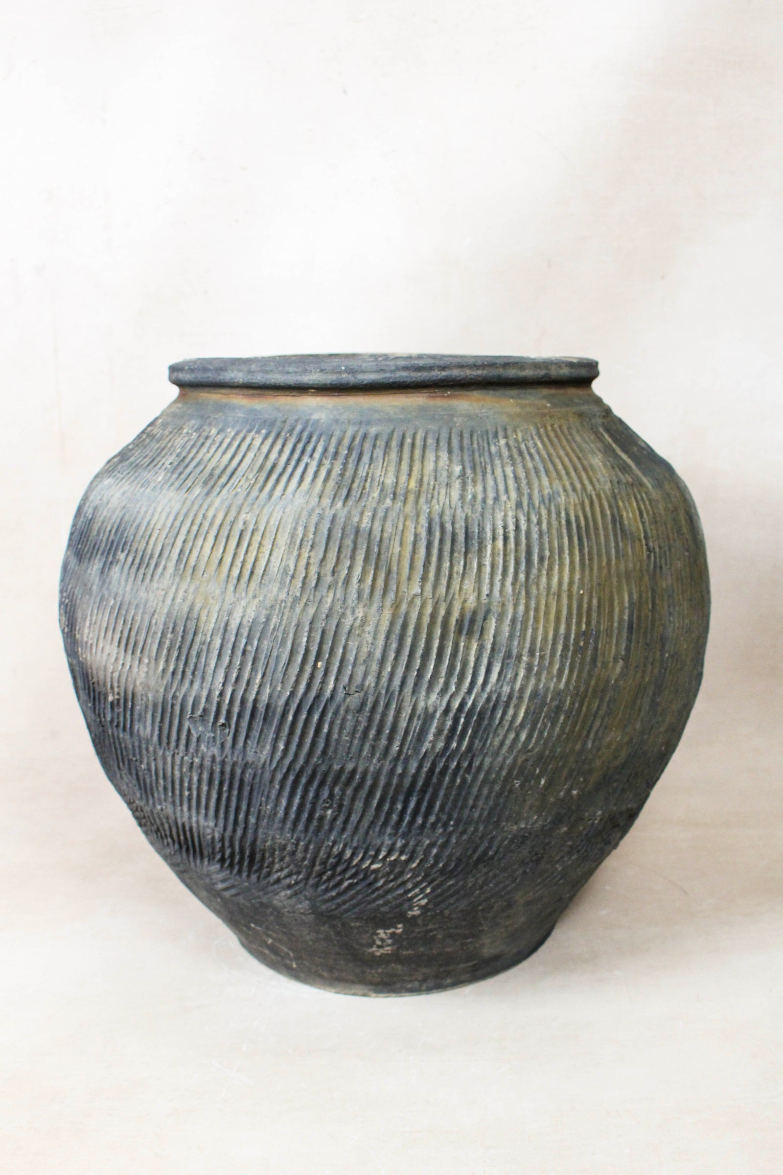 Vintage grey clay pot — side view showing the aged patina