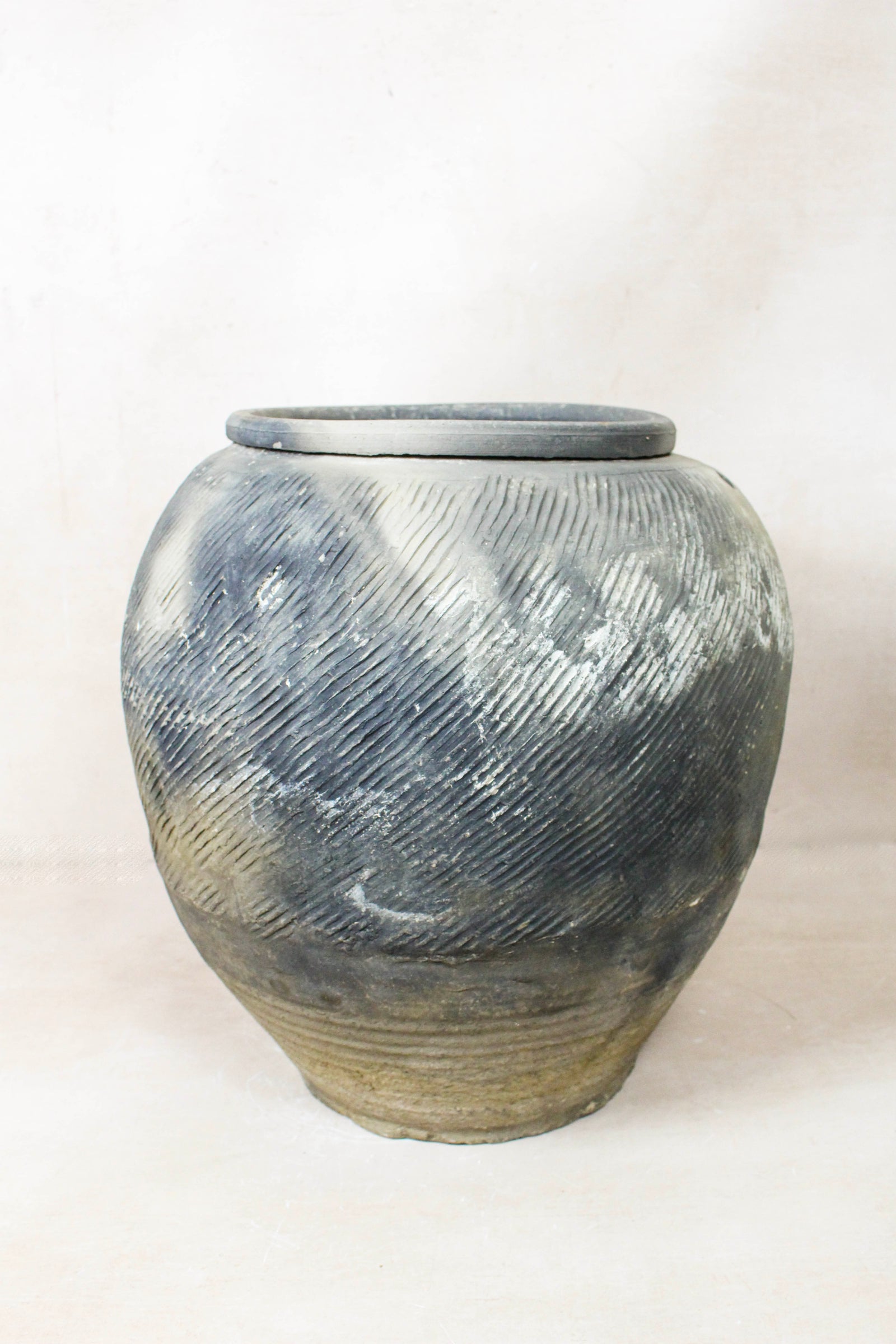 Vintage grey clay pot — detail of the textured firing marks