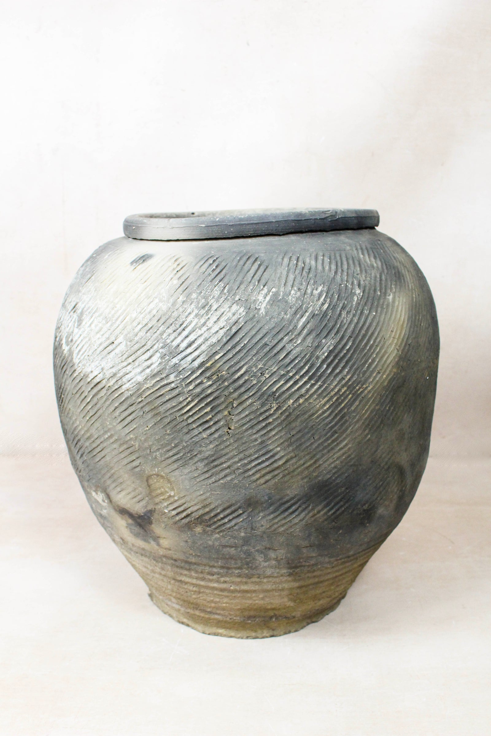 Vintage grey clay pot — side view showing the aged patina