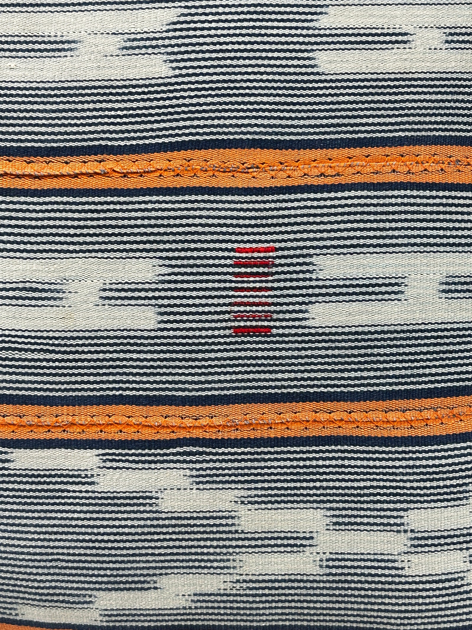 Baule cloth cushion — detail of the hand-stitched strip weave