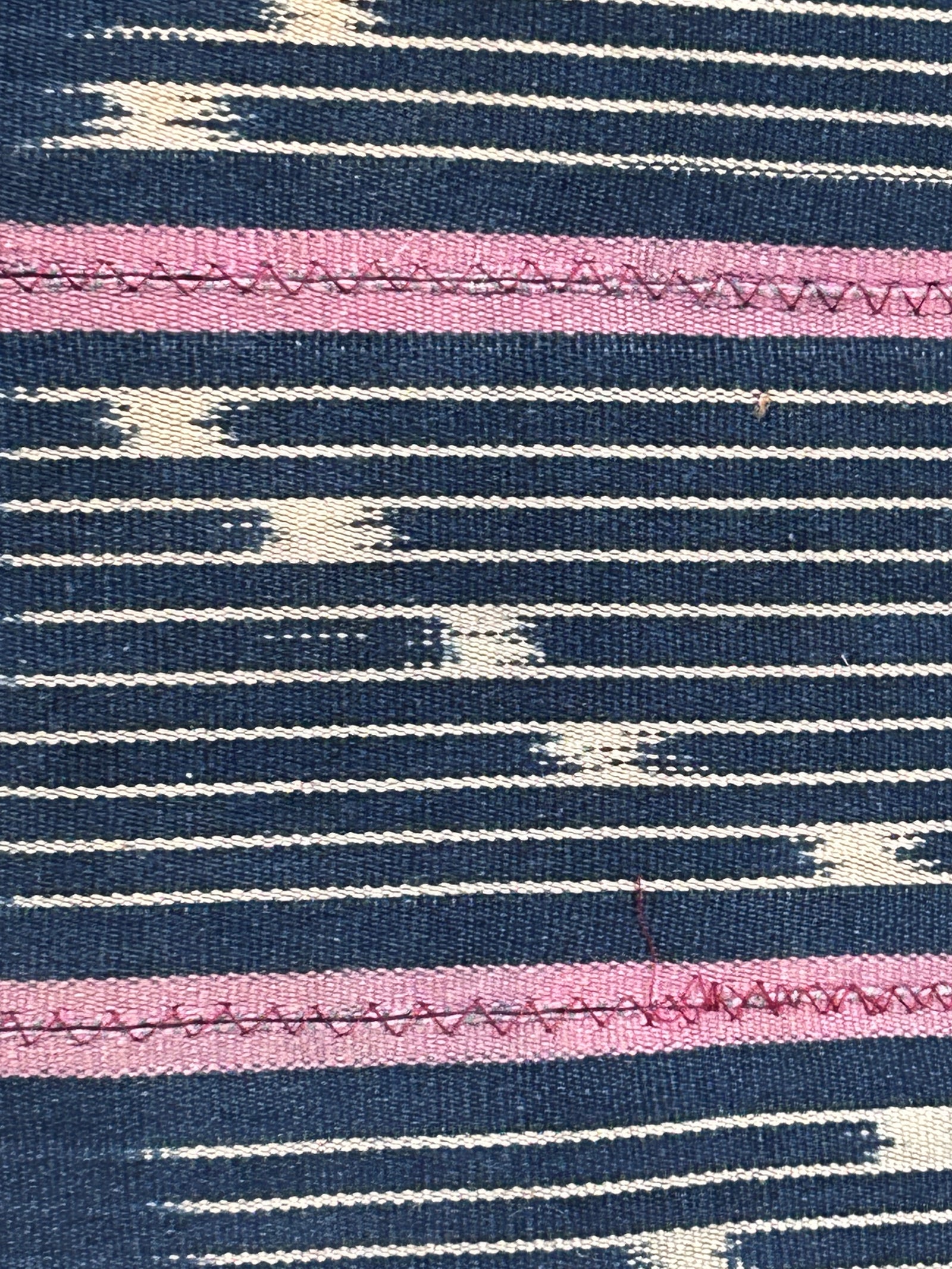 Baule cloth cushion — detail of the hand-stitched strip weave