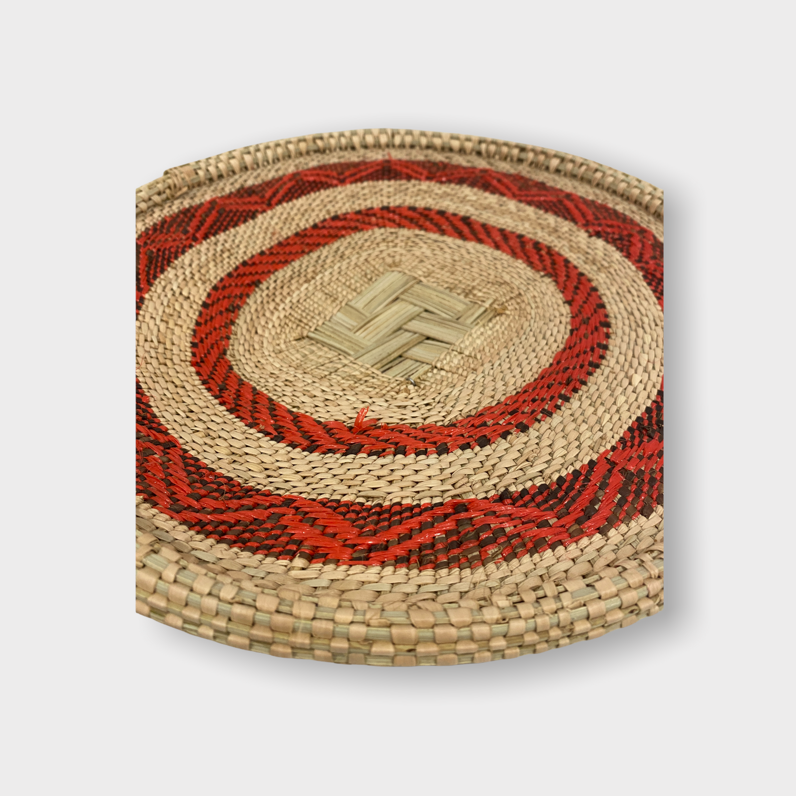 Handwoven Tonga winnowing basket in red recycled fibre, Zimbabwe