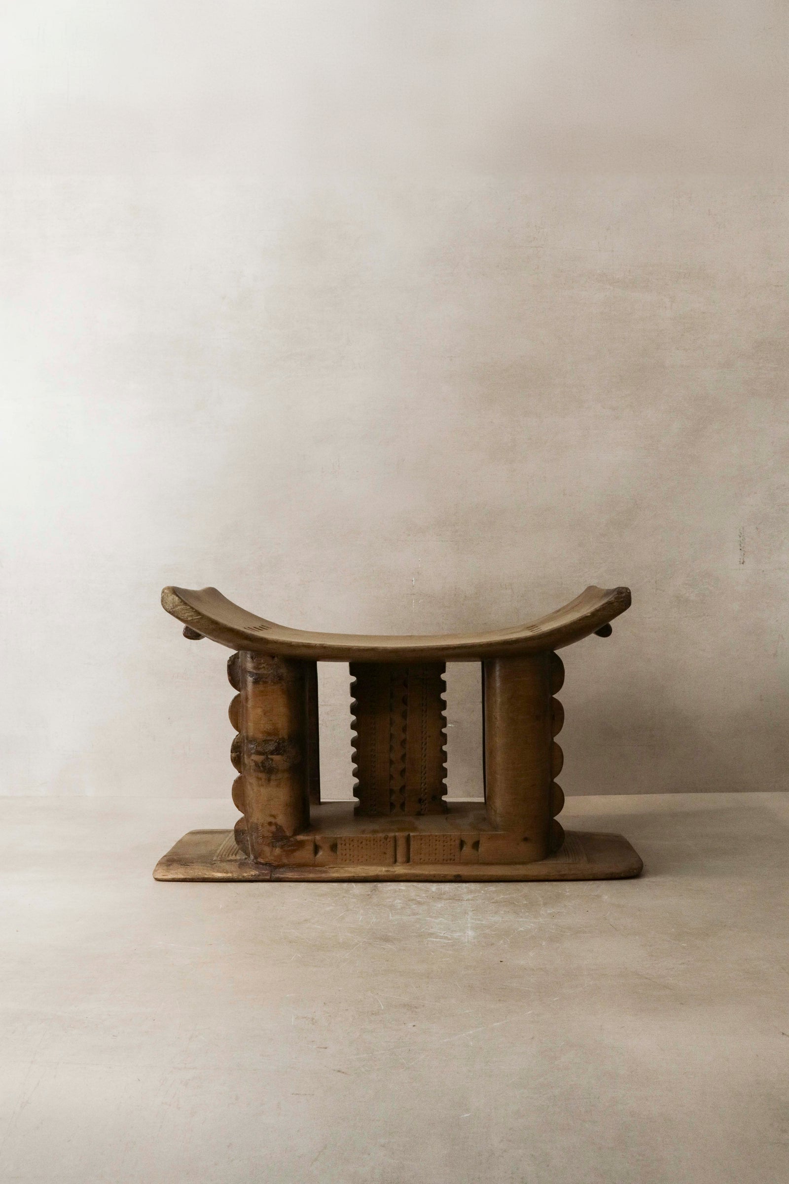 Hand-carved Ashanti stool from Ghana with crescent seat, carved from a single piece of wood
