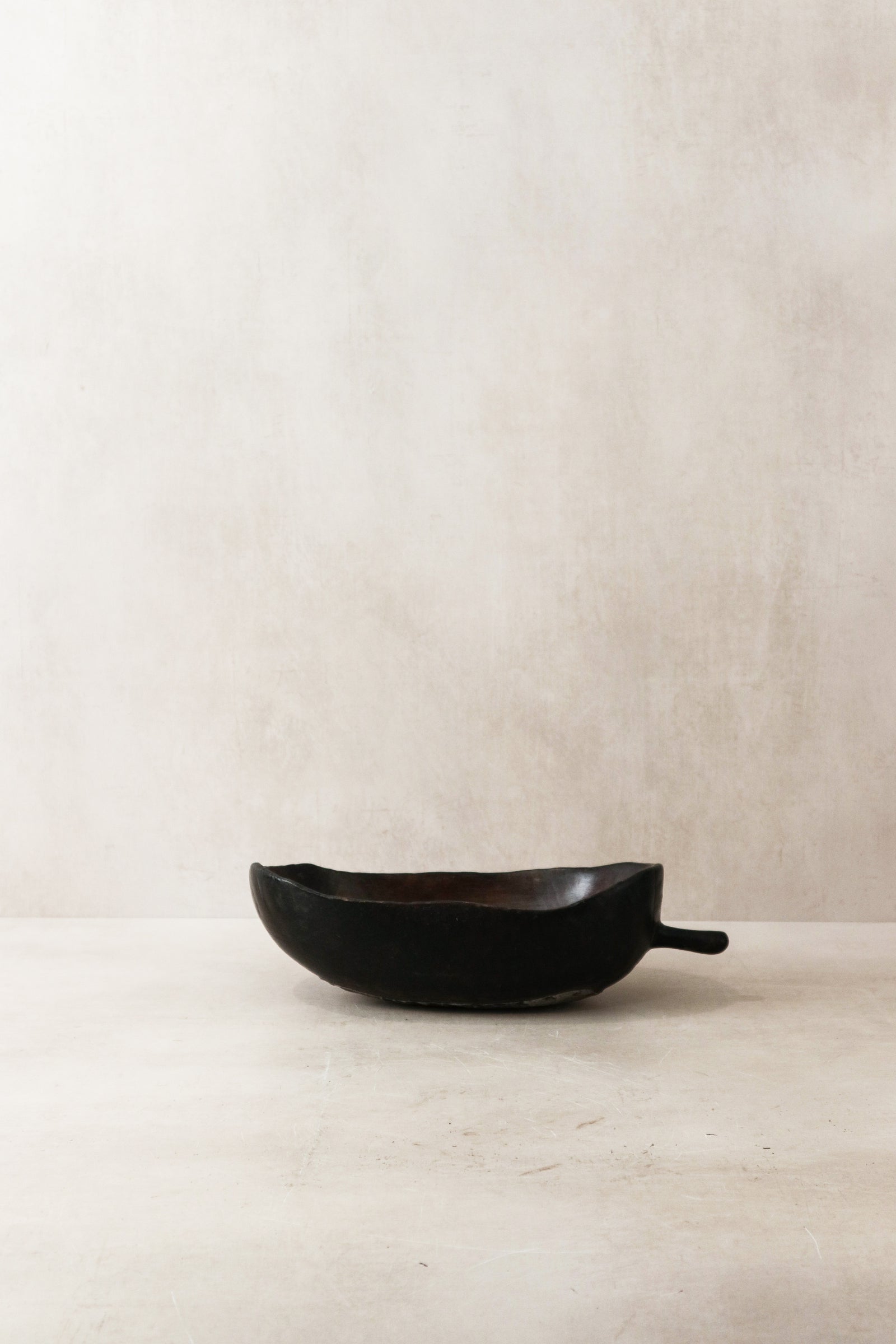 Tutsi bowl — side view showing the carved form