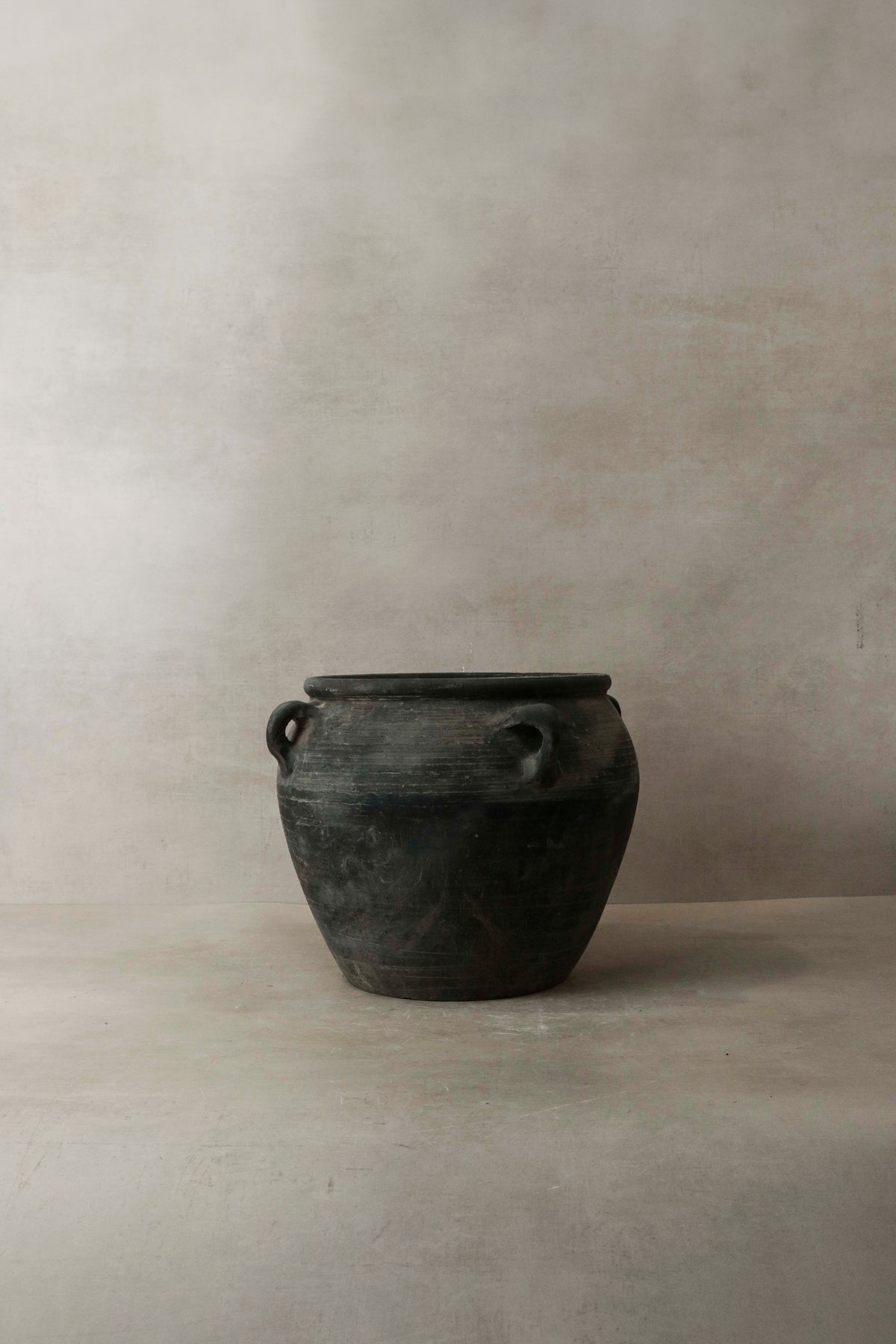 Vintage dark pot with ears — opening from above