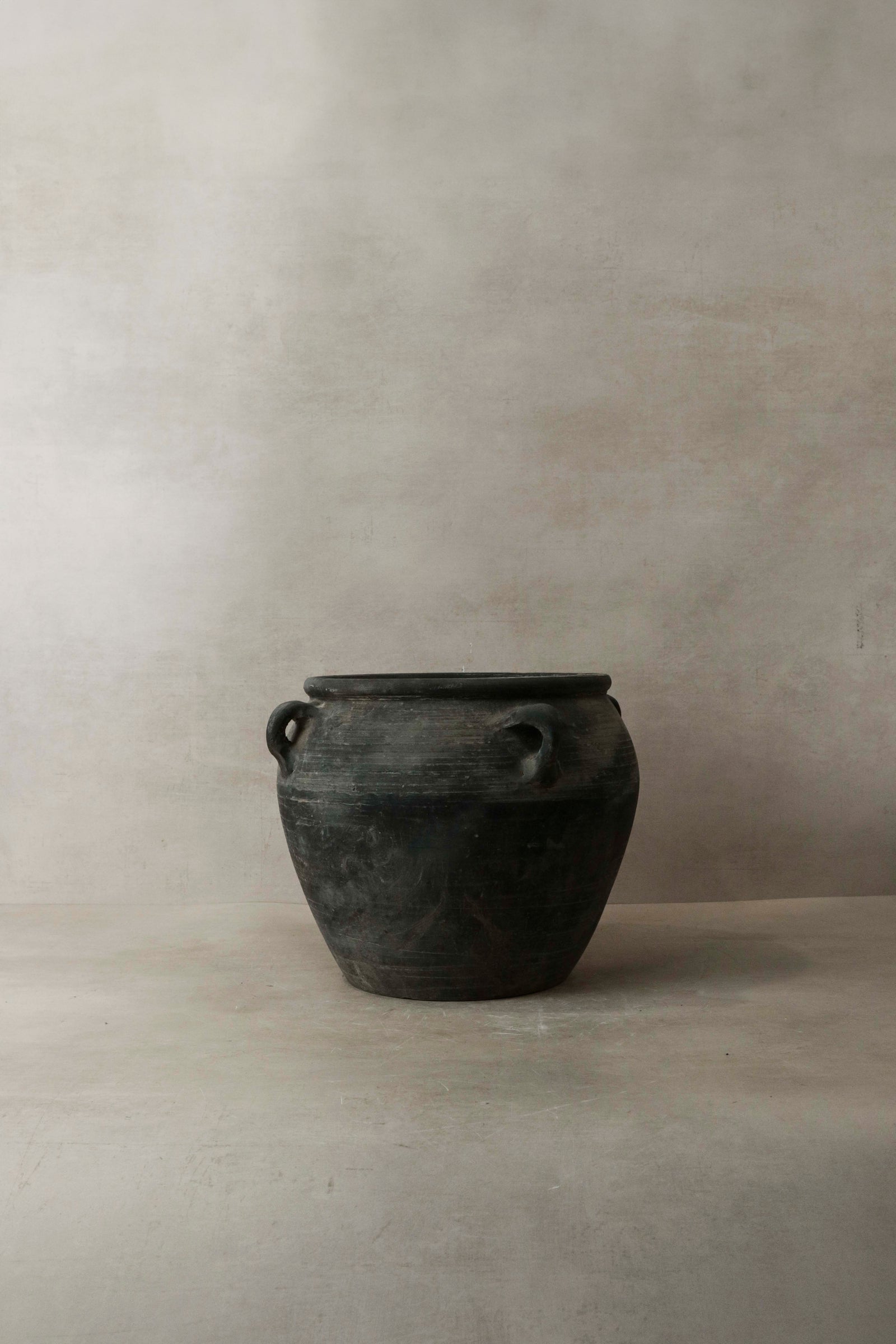 Vintage dark pot with ears — opening from above