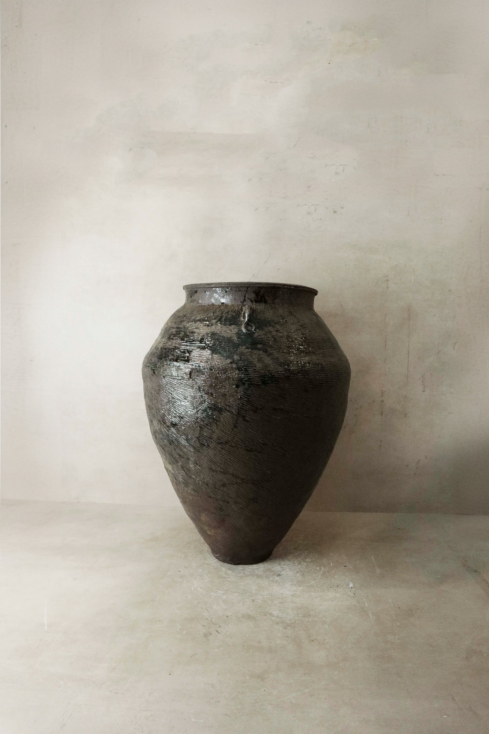 Vintage brown-glazed Asian pot — detail of the pooling glaze
