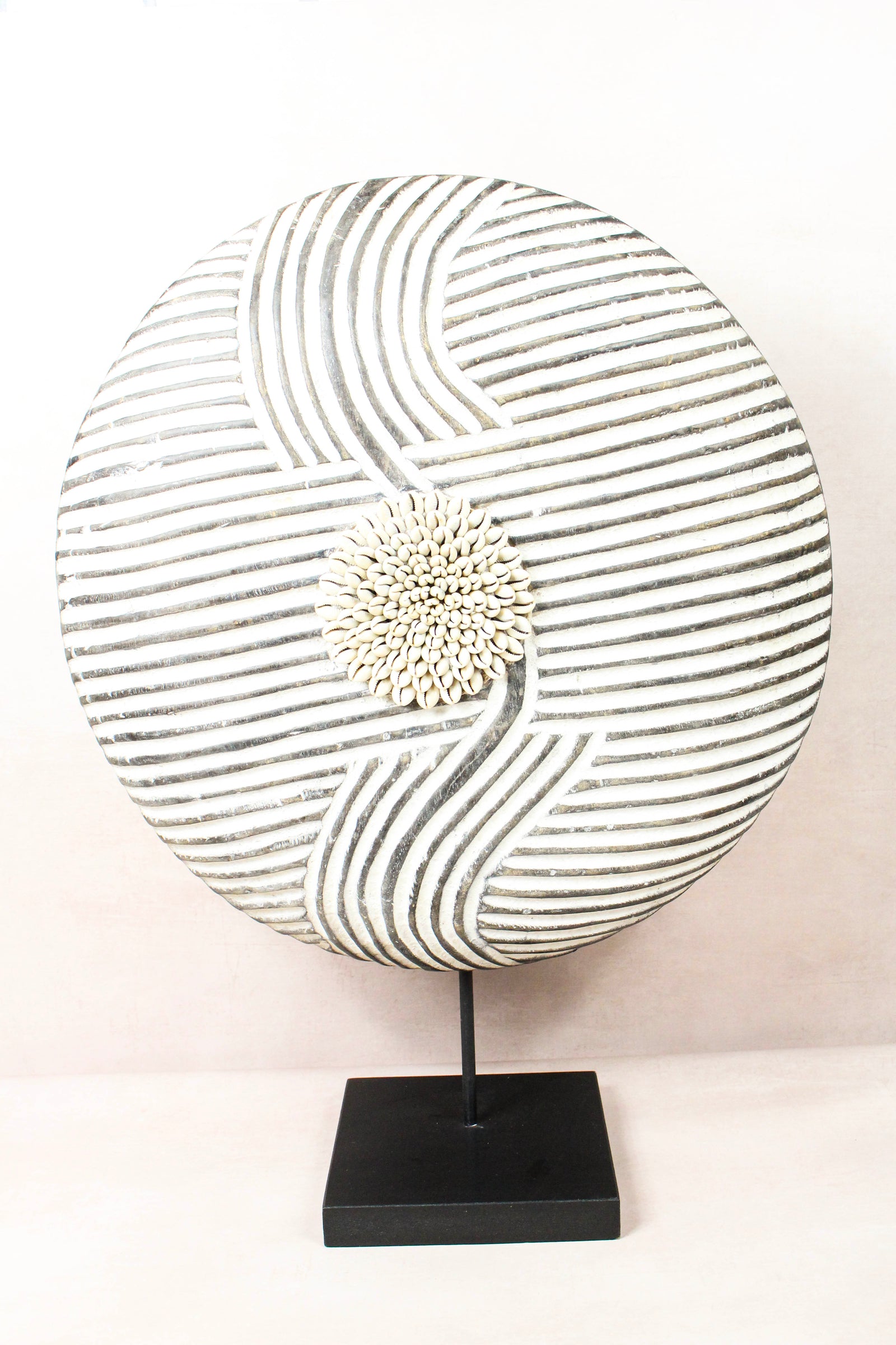 Cameroon Bamun round shield in blackened wood and white kaolin clay, on a steel stand