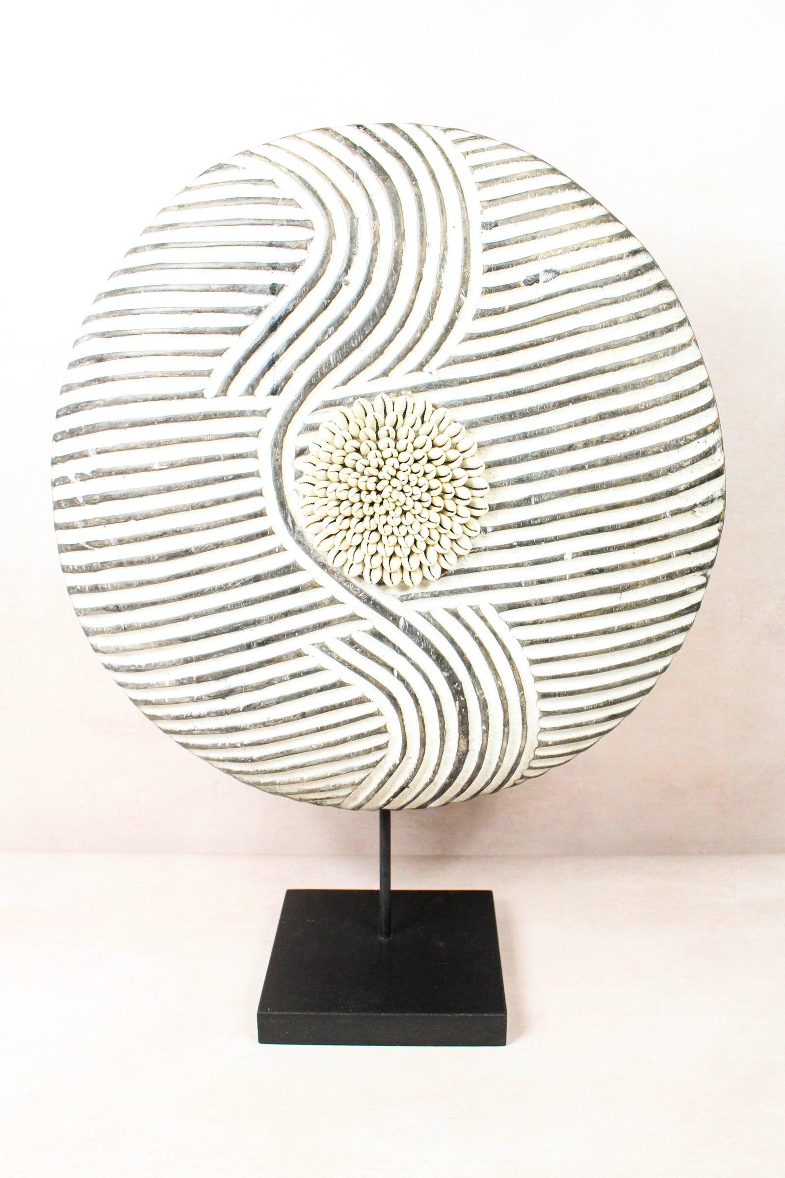 Cameroon Bamun round shield in blackened wood and white kaolin clay, on a steel stand
