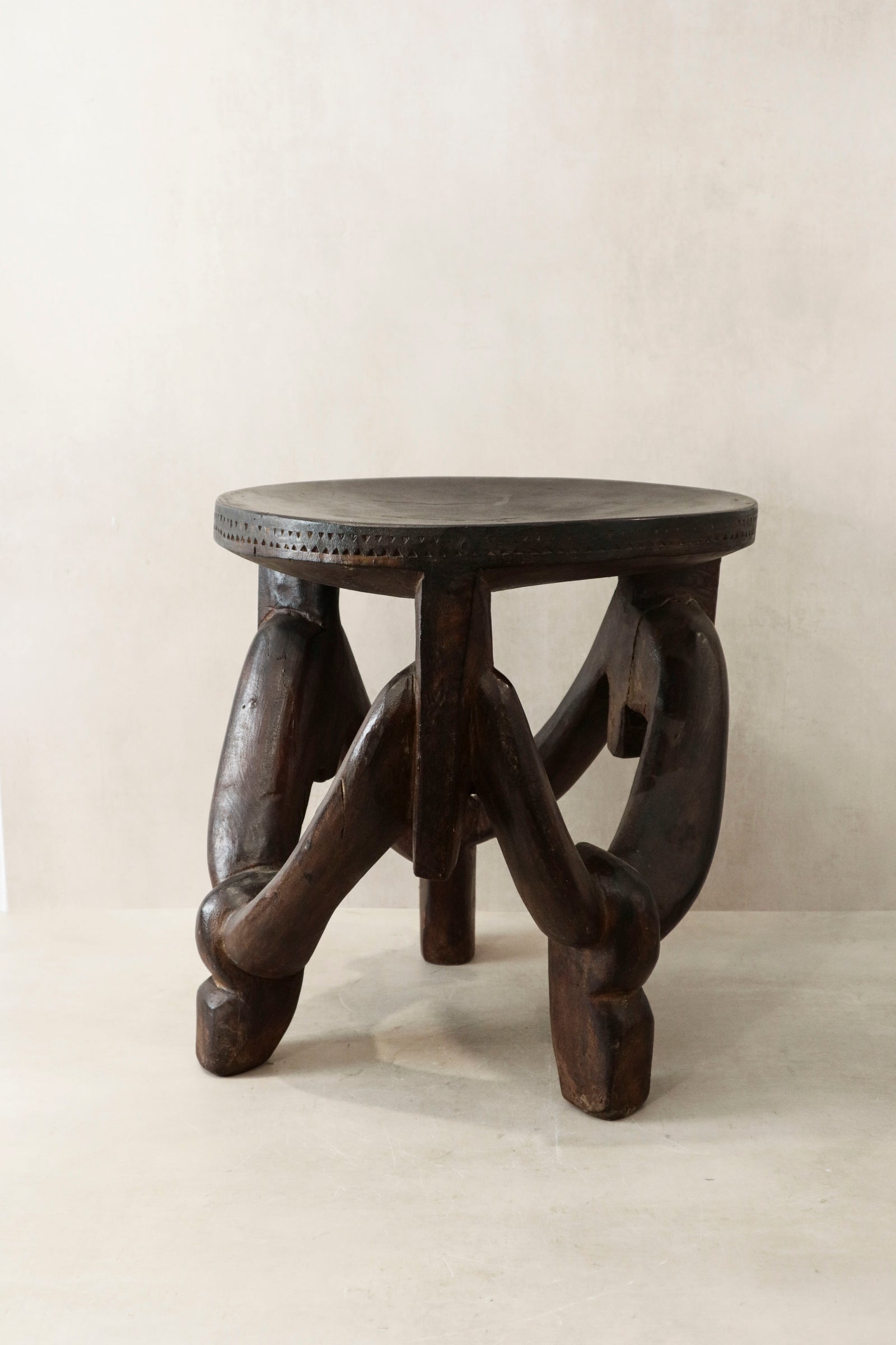 Hand-carved Makonde stool from Tanzania, carved from a single piece of wood