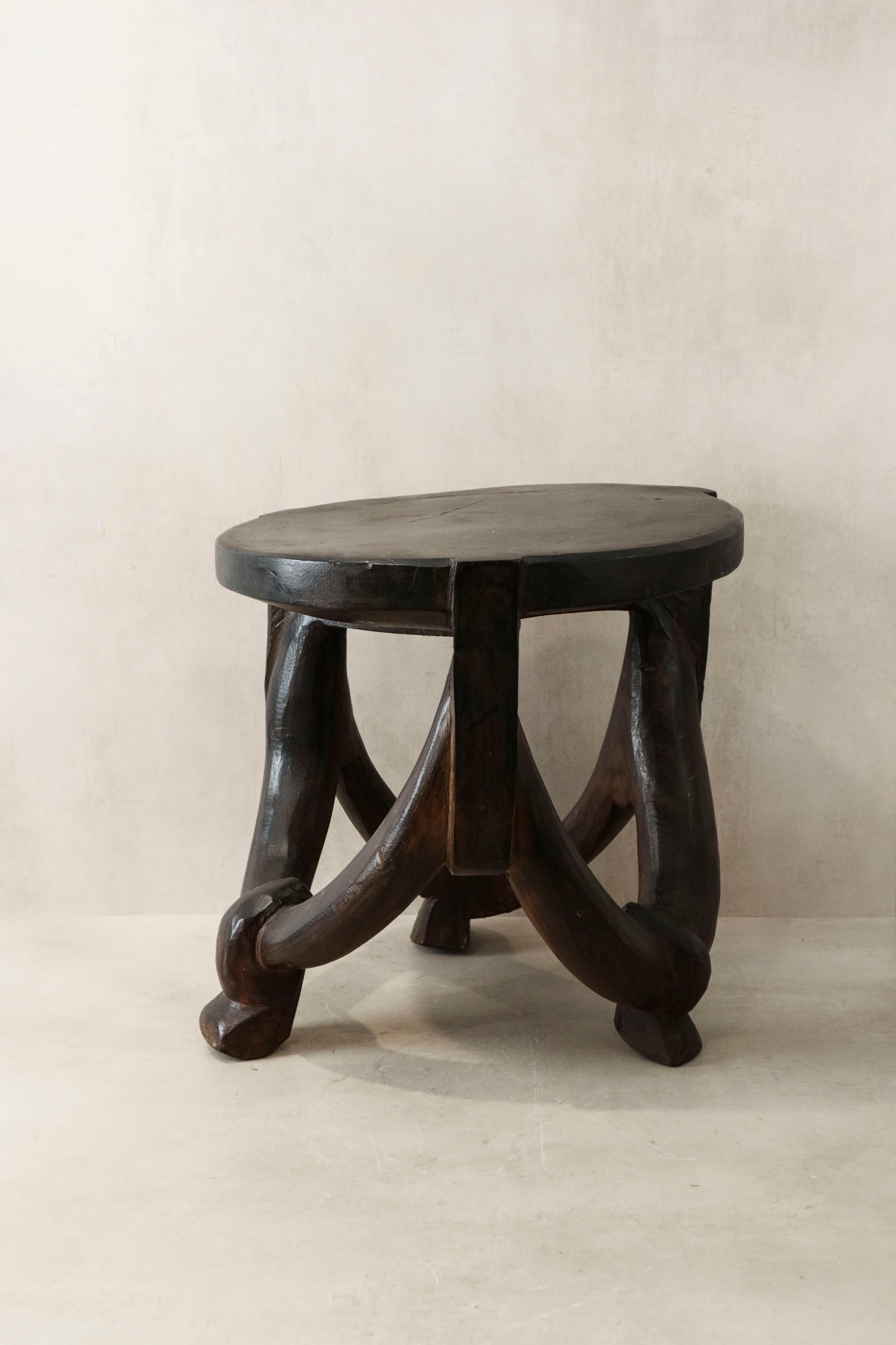Hand-carved Makonde stool from Tanzania, carved from a single piece of wood