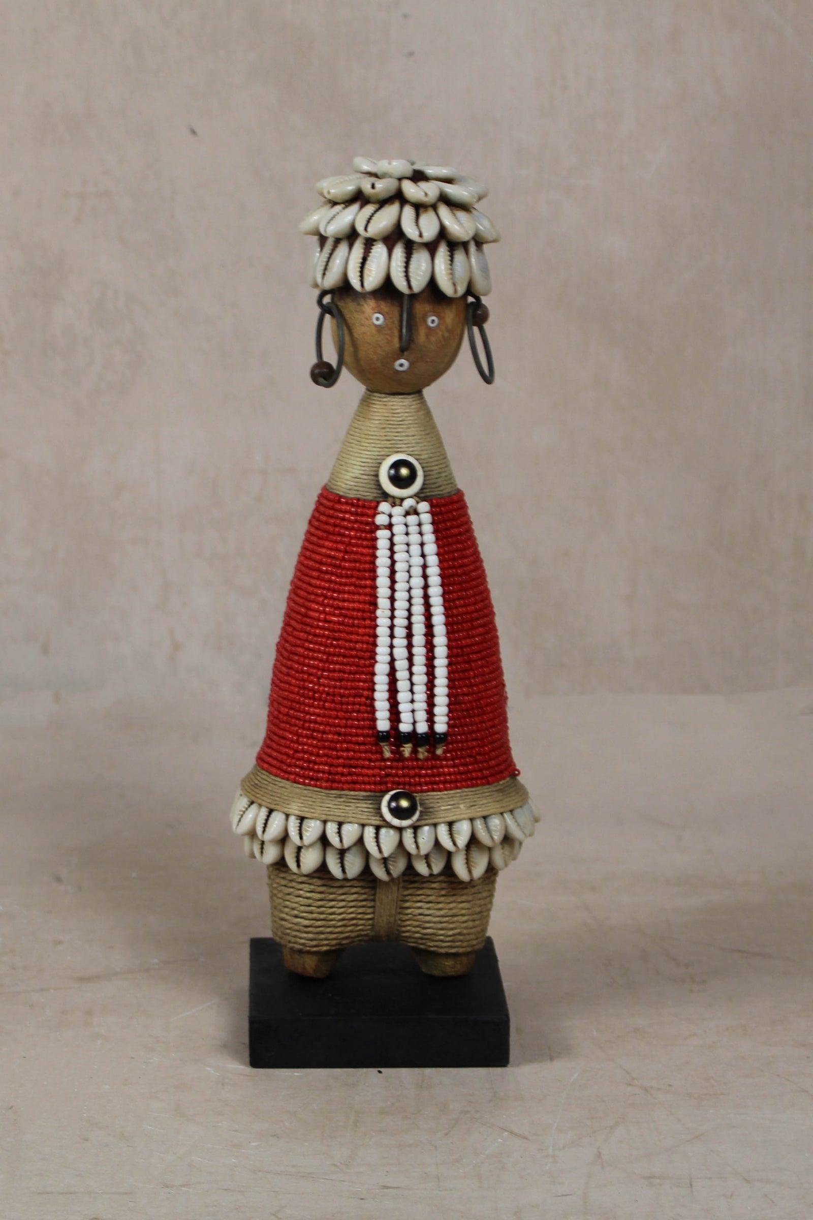 Hand-carved red beaded Namji doll from Cameroon