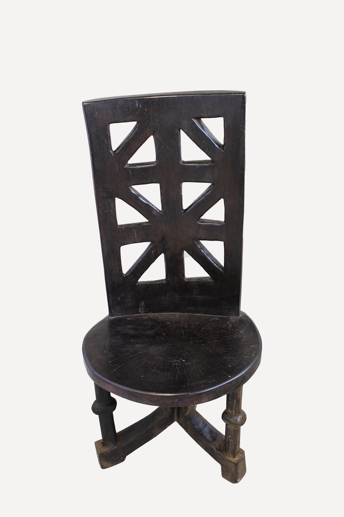Hand-carved Makonde chair from Tanzania with a sculpted ancestor head on the backrest