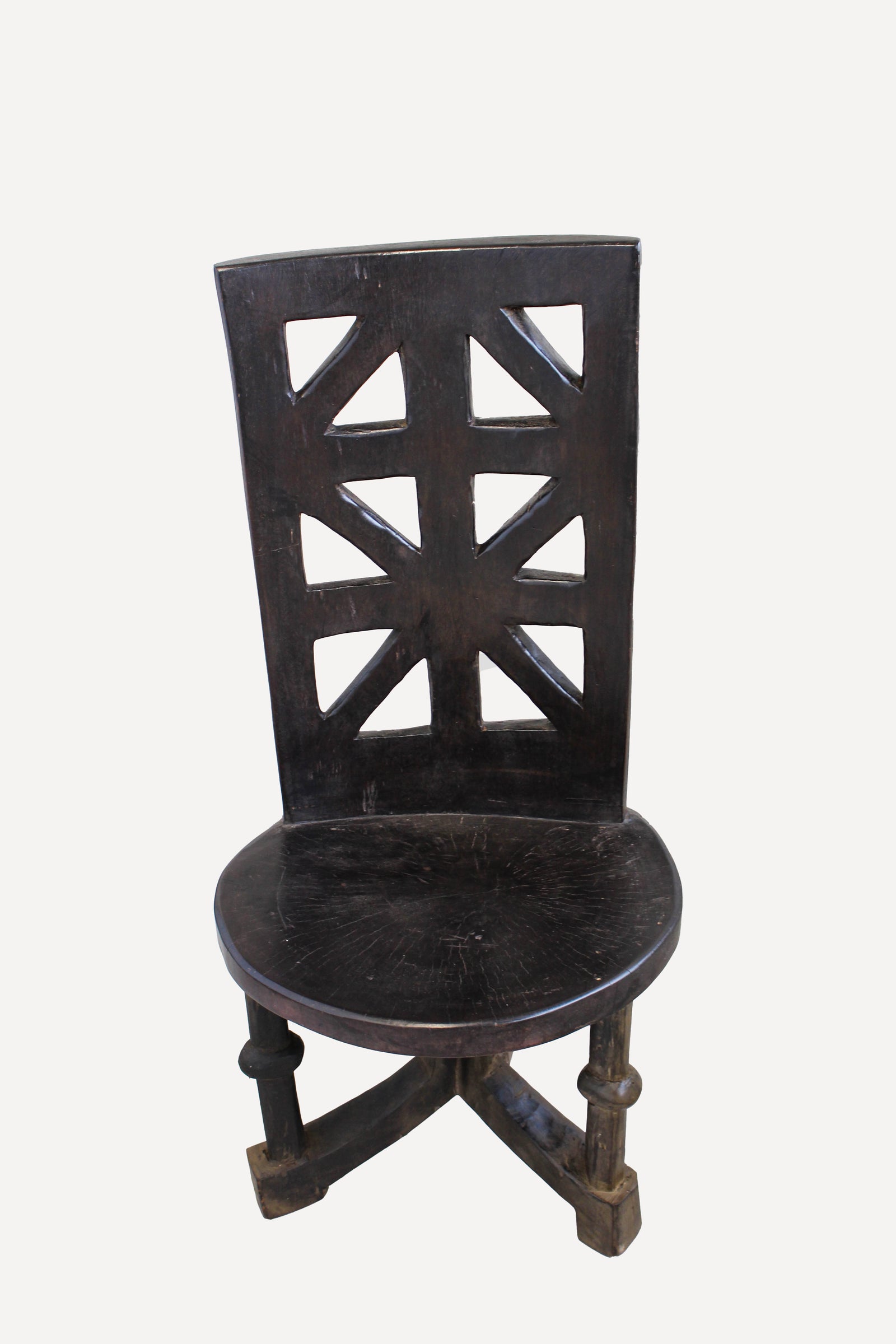 Hand-carved Makonde chair from Tanzania with a sculpted ancestor head on the backrest