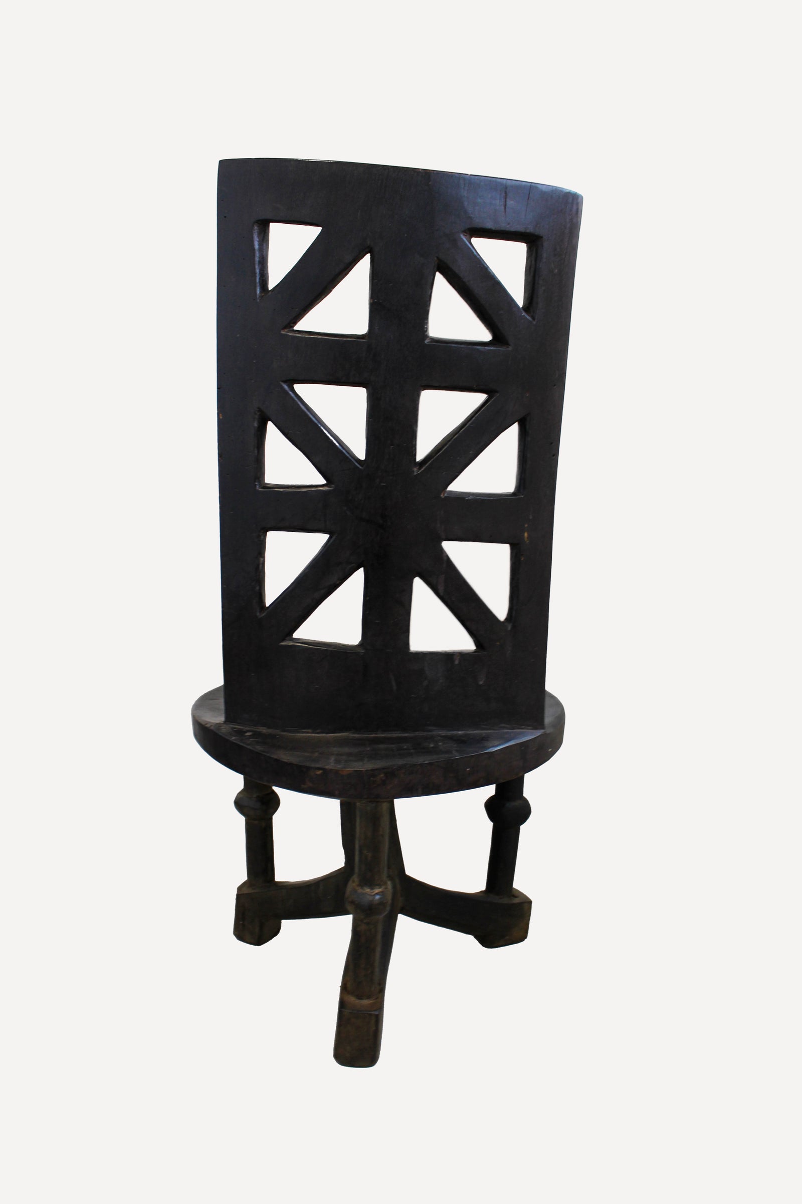 Detail of the ancestor head and hands carved into the Makonde chair backrest