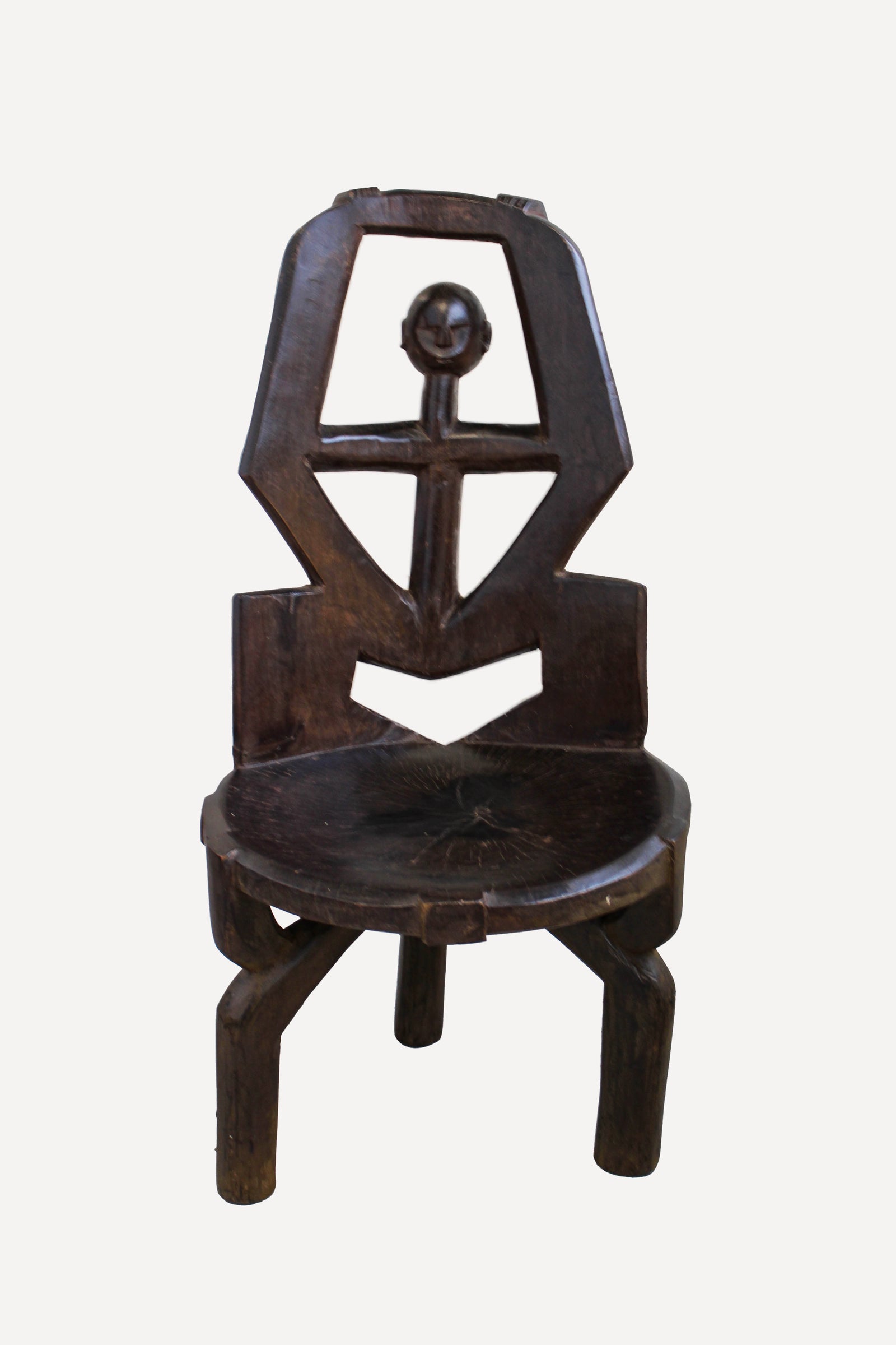 Hand-carved Makonde chair from Tanzania with a sculpted ancestor head on the backrest