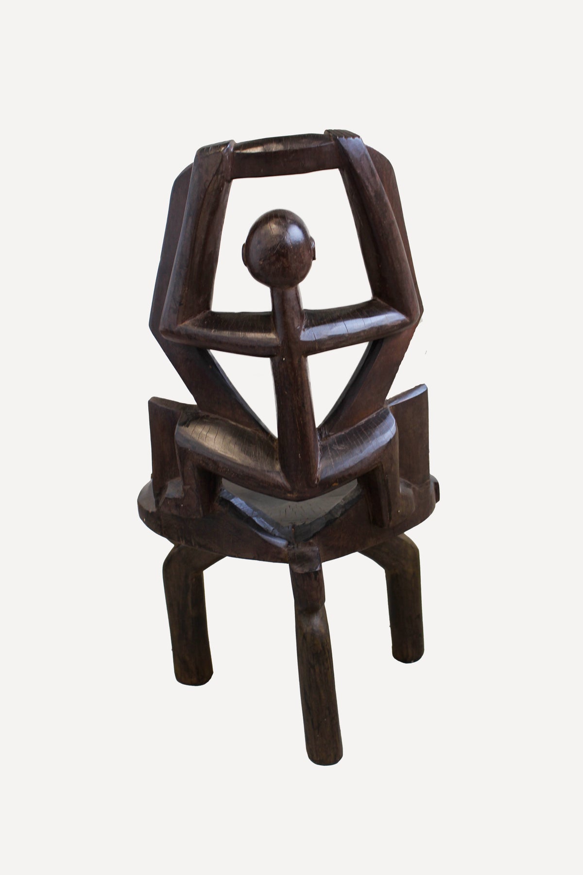 Detail of the ancestor head and hands carved into the Makonde chair backrest