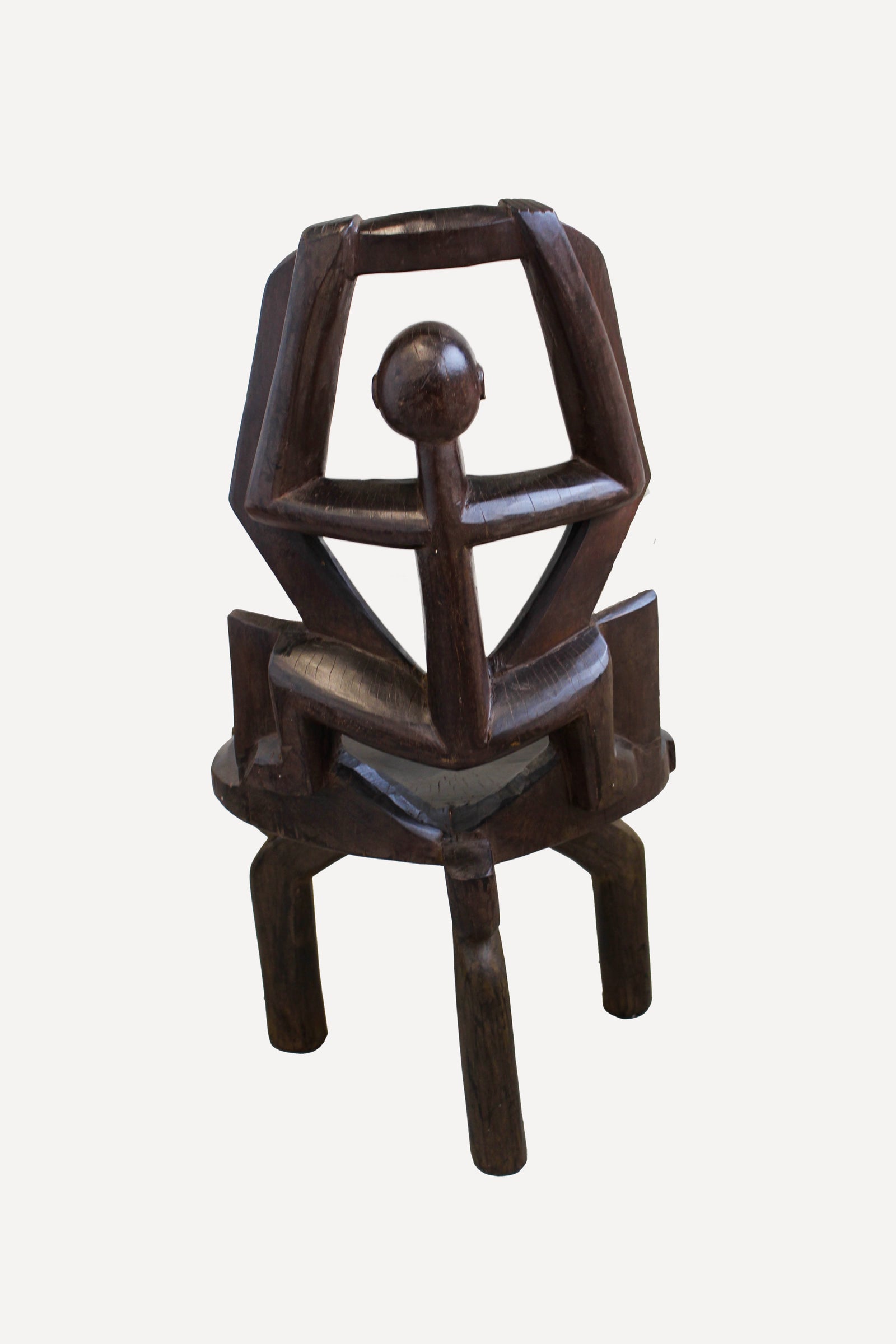 Detail of the ancestor head and hands carved into the Makonde chair backrest