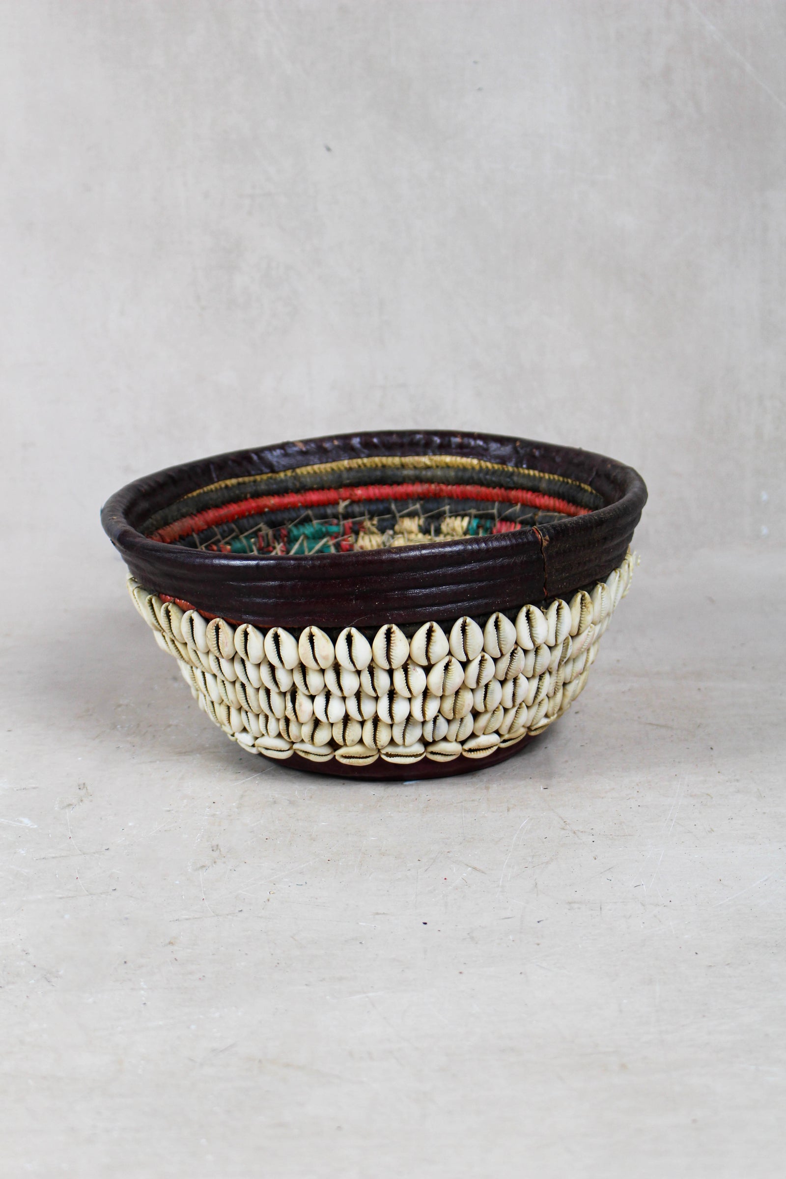 Vintage Hausa cowrie shell bowl from Northern Nigeria, woven grass with leather rim