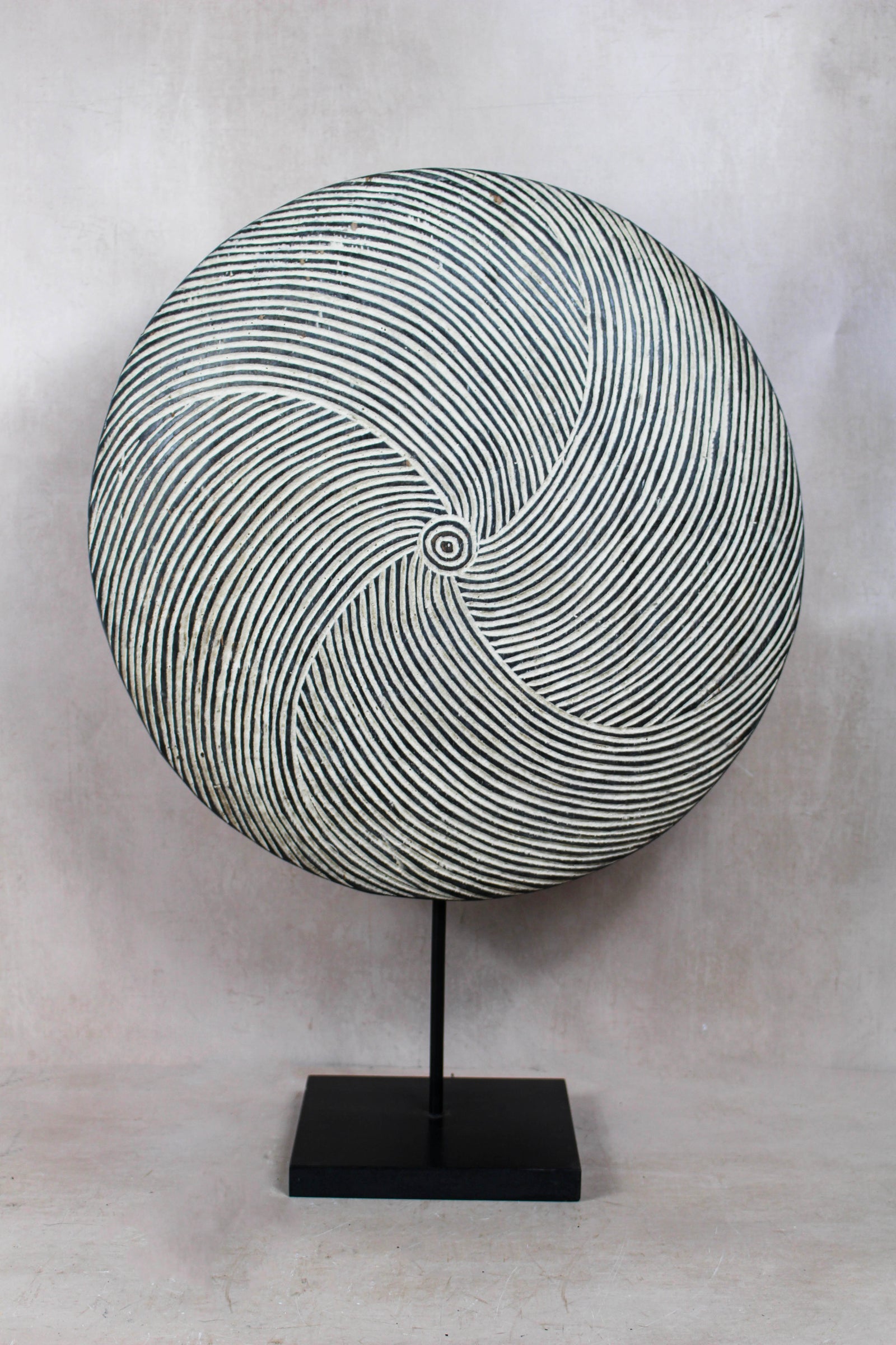 Large handmade Cameroon round shield with a bold geometric design, on a stand