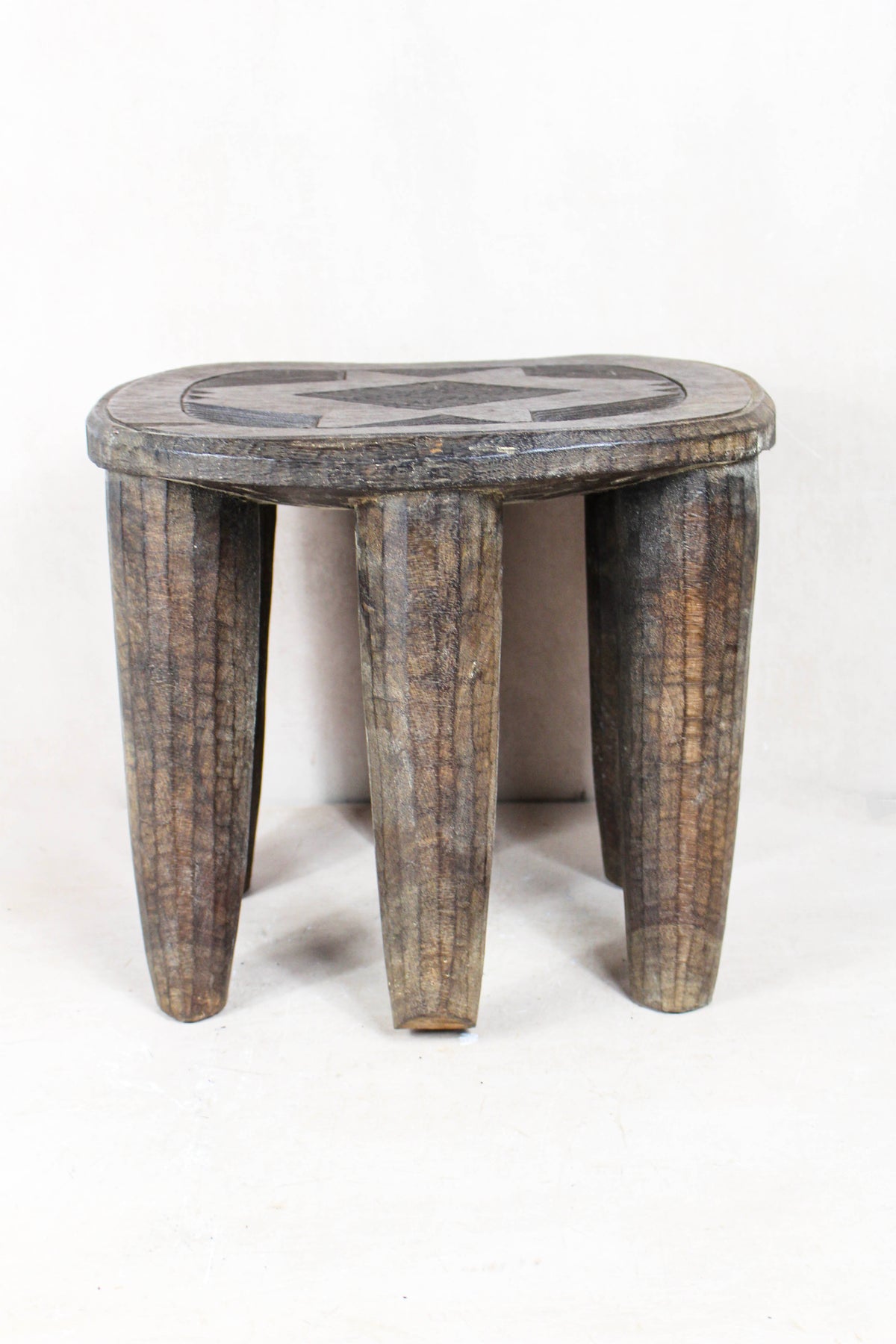 Hand-carved Nupe wood stool from Nigeria with incised geometric patterns