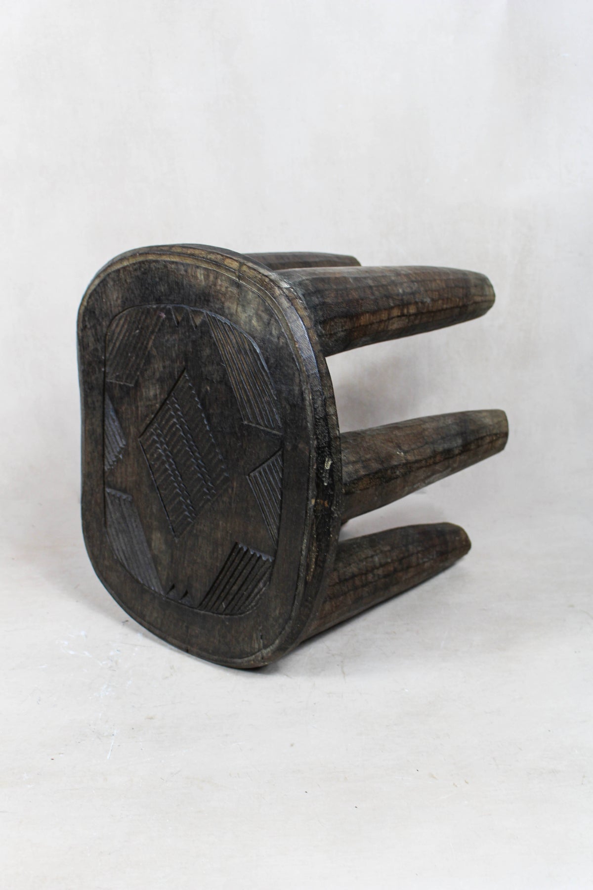 Nupe carved wood stool — detail of the carved pattern