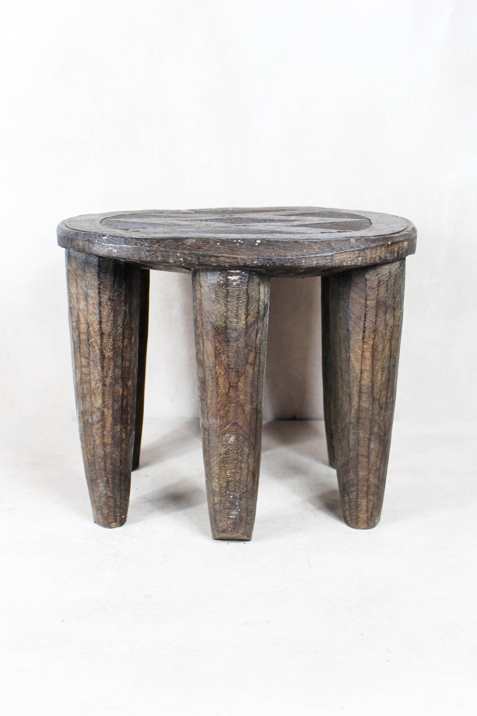 Hand-carved Nupe wood stool from Nigeria with incised geometric patterns