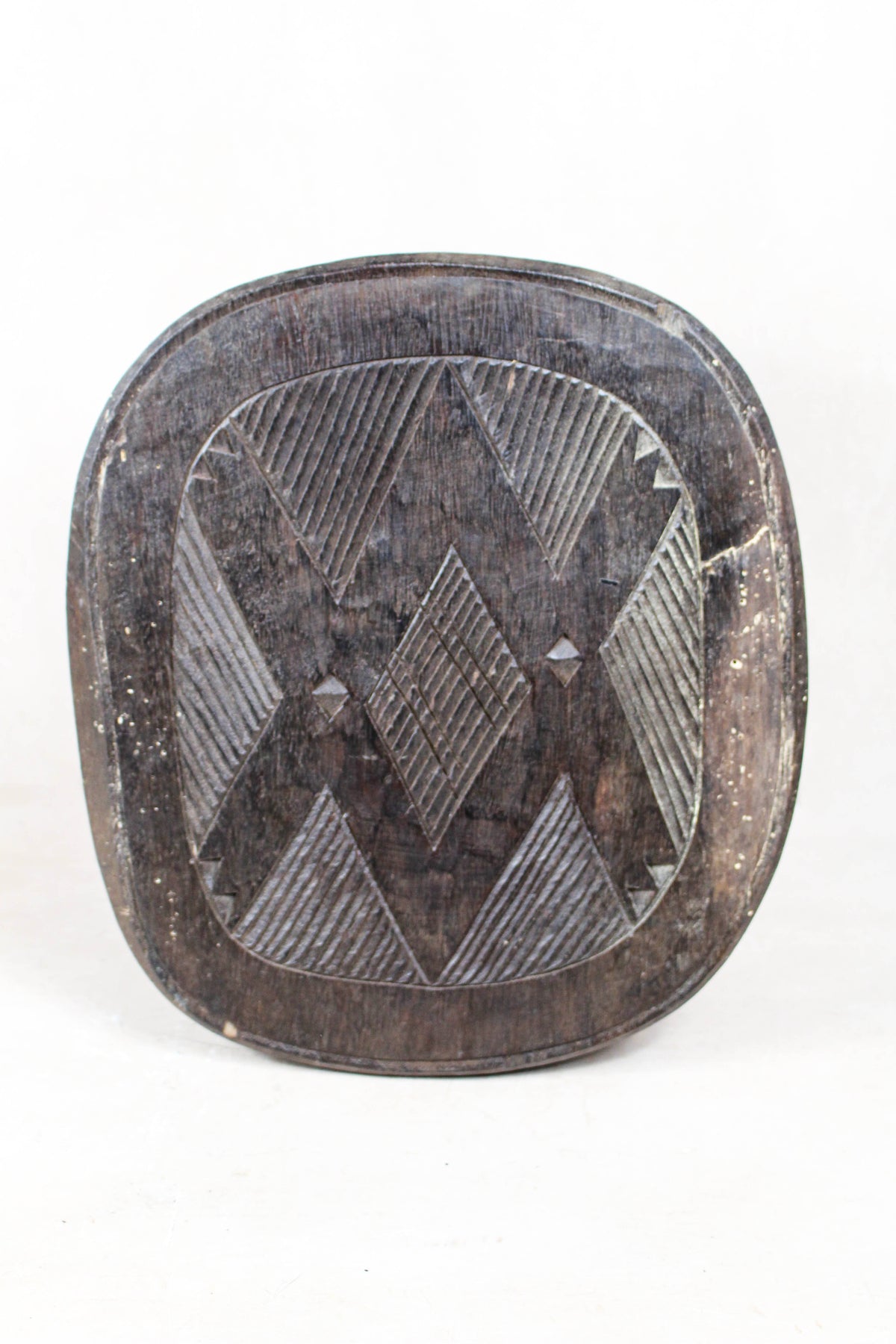 Nupe carved wood stool, Nigeria — side view