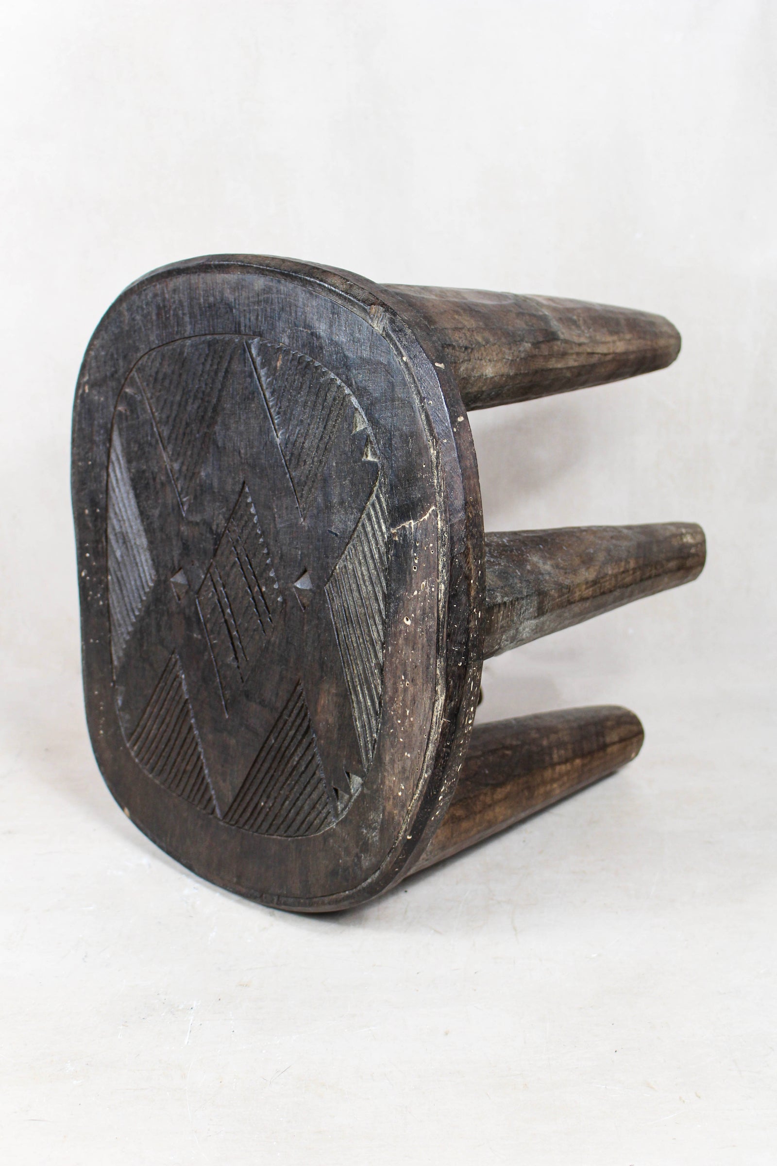 Nupe carved wood stool — detail of the carved pattern