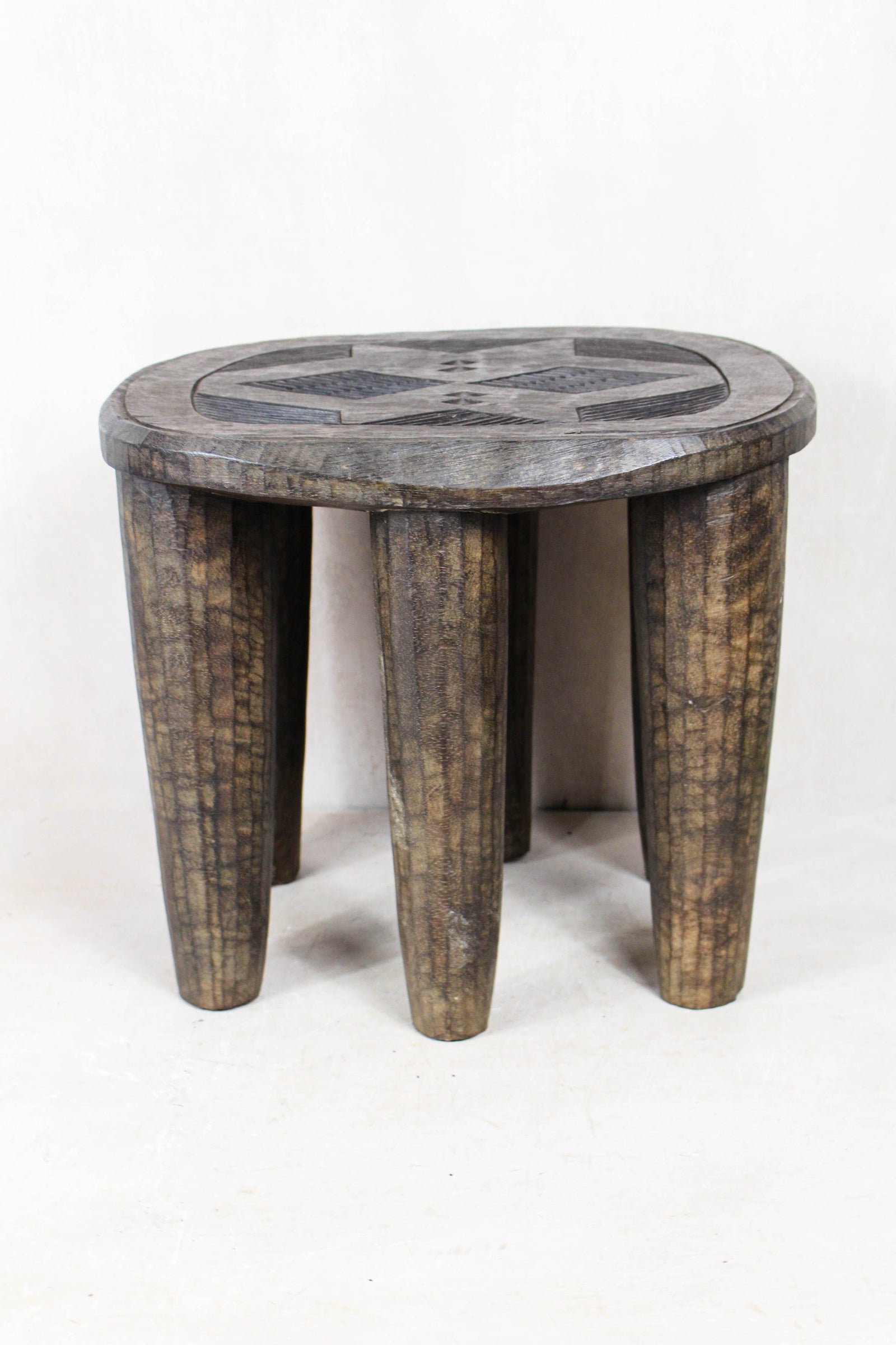 Hand-carved Nupe wood stool from Nigeria with incised geometric patterns