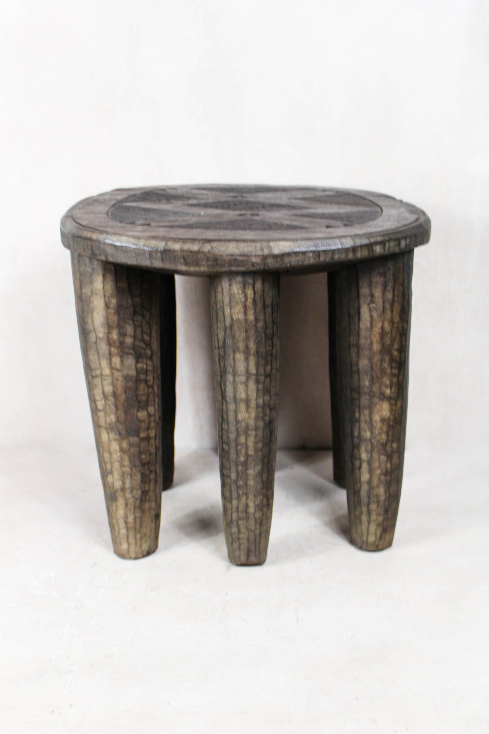 Hand-carved Nupe wood stool from Nigeria with incised geometric patterns