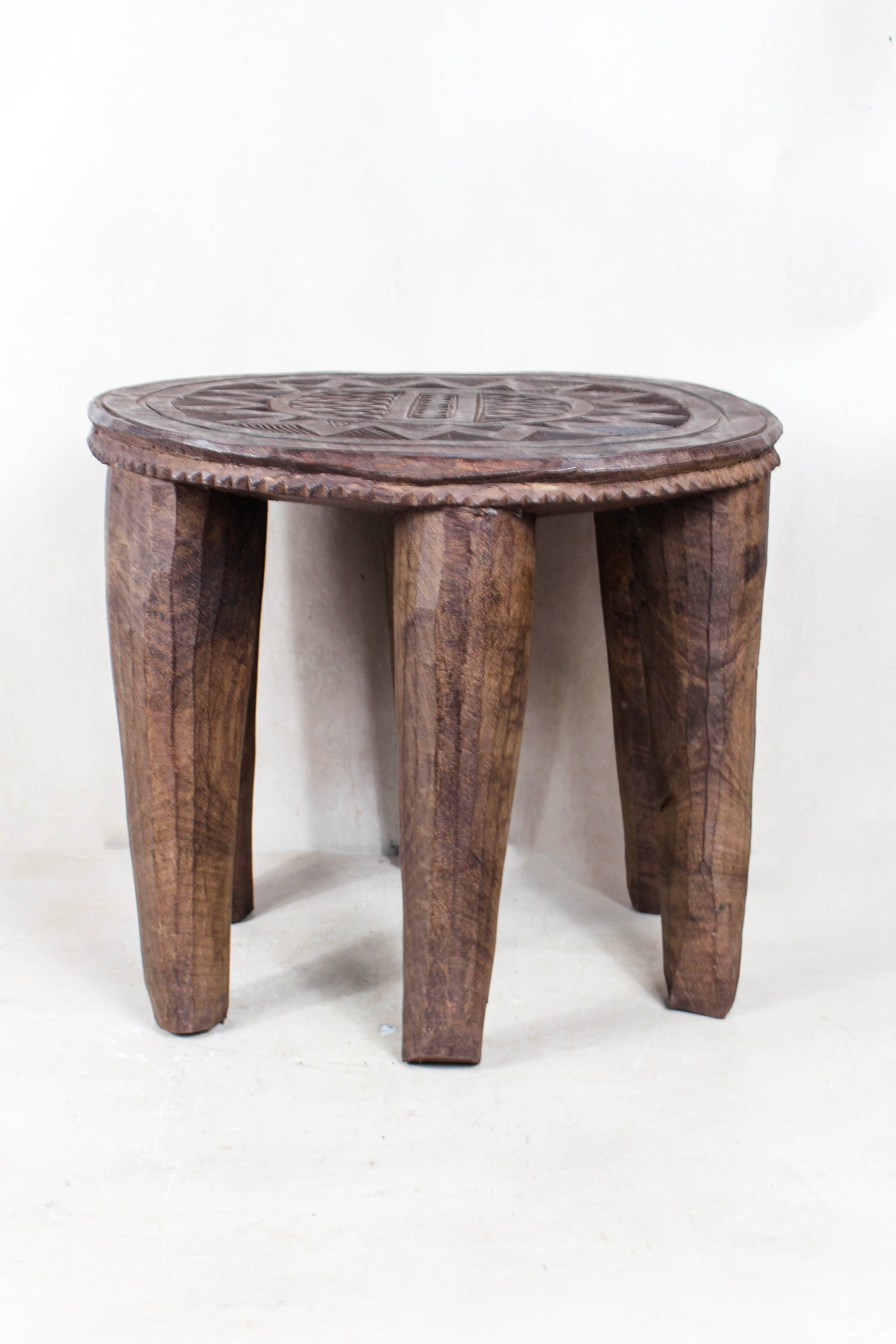 Hand-carved Nupe wood stool from Nigeria with incised geometric patterns