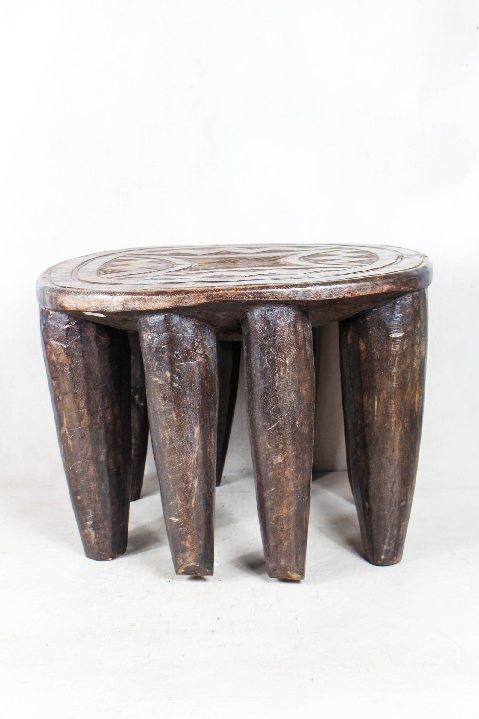 Hand-carved Nupe wood stool from Nigeria with incised geometric patterns